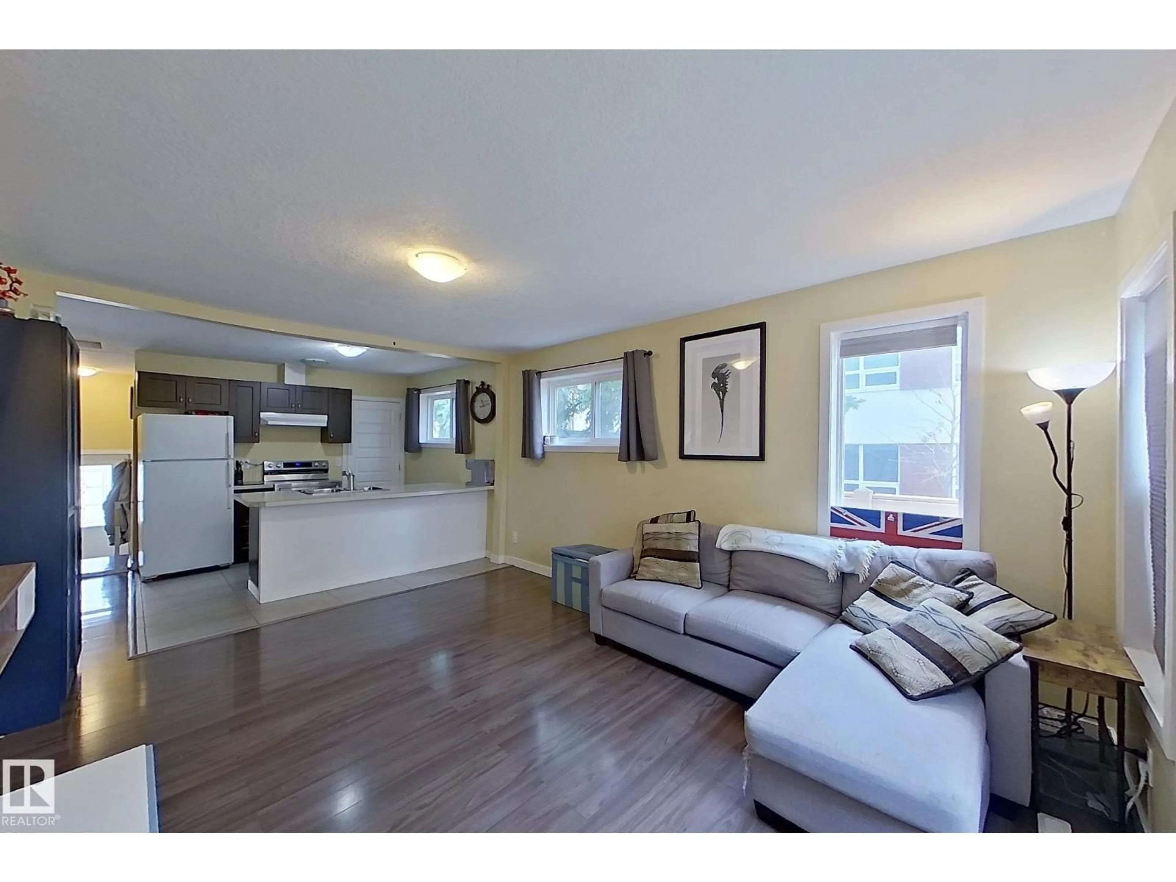 Living room with furniture, wood/laminate floor for 11612 130 AV, Edmonton Alberta T5E0V1