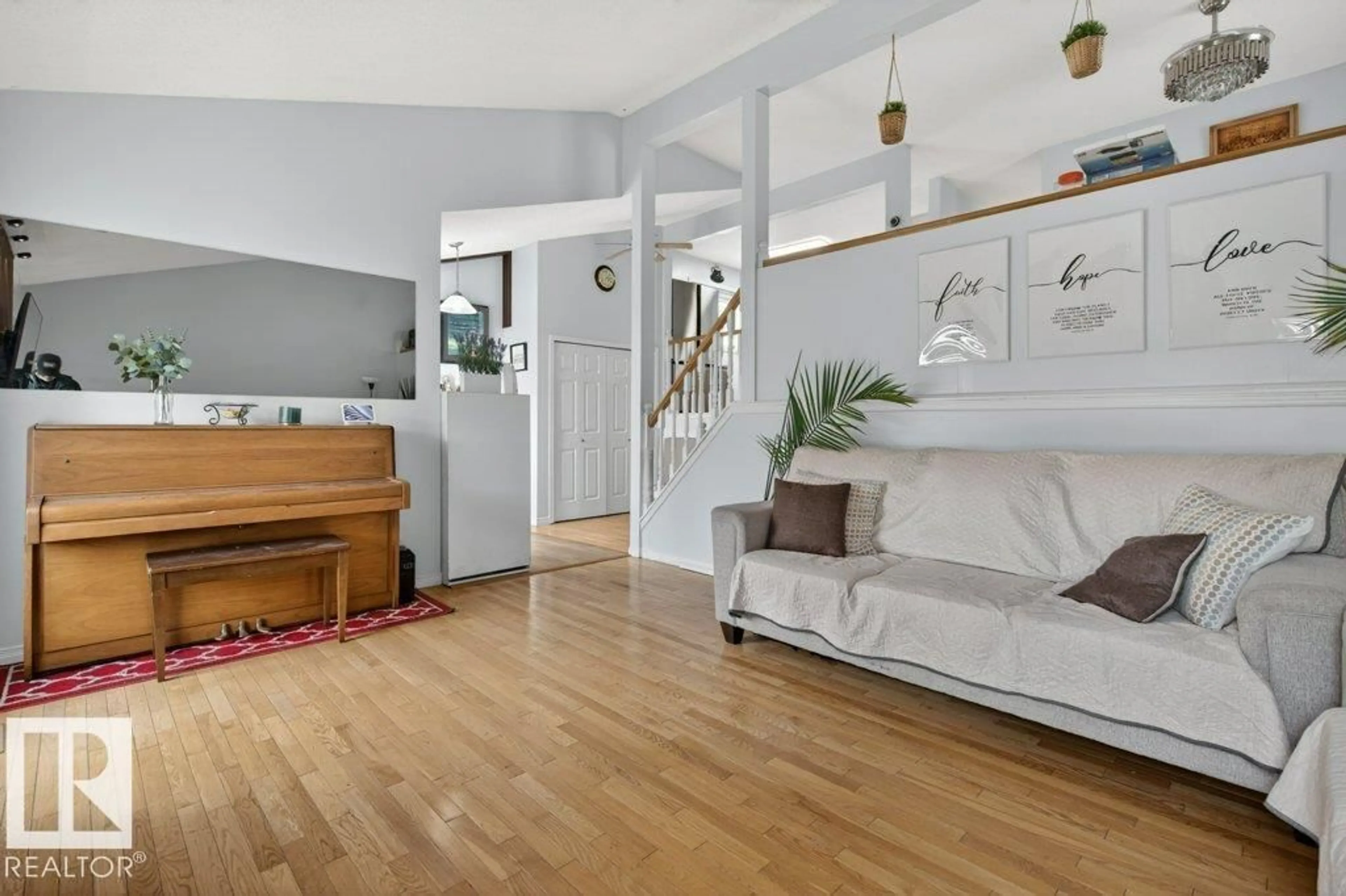 Living room with furniture, wood/laminate floor for 157 KINISKI CR, Edmonton Alberta T6L5E2