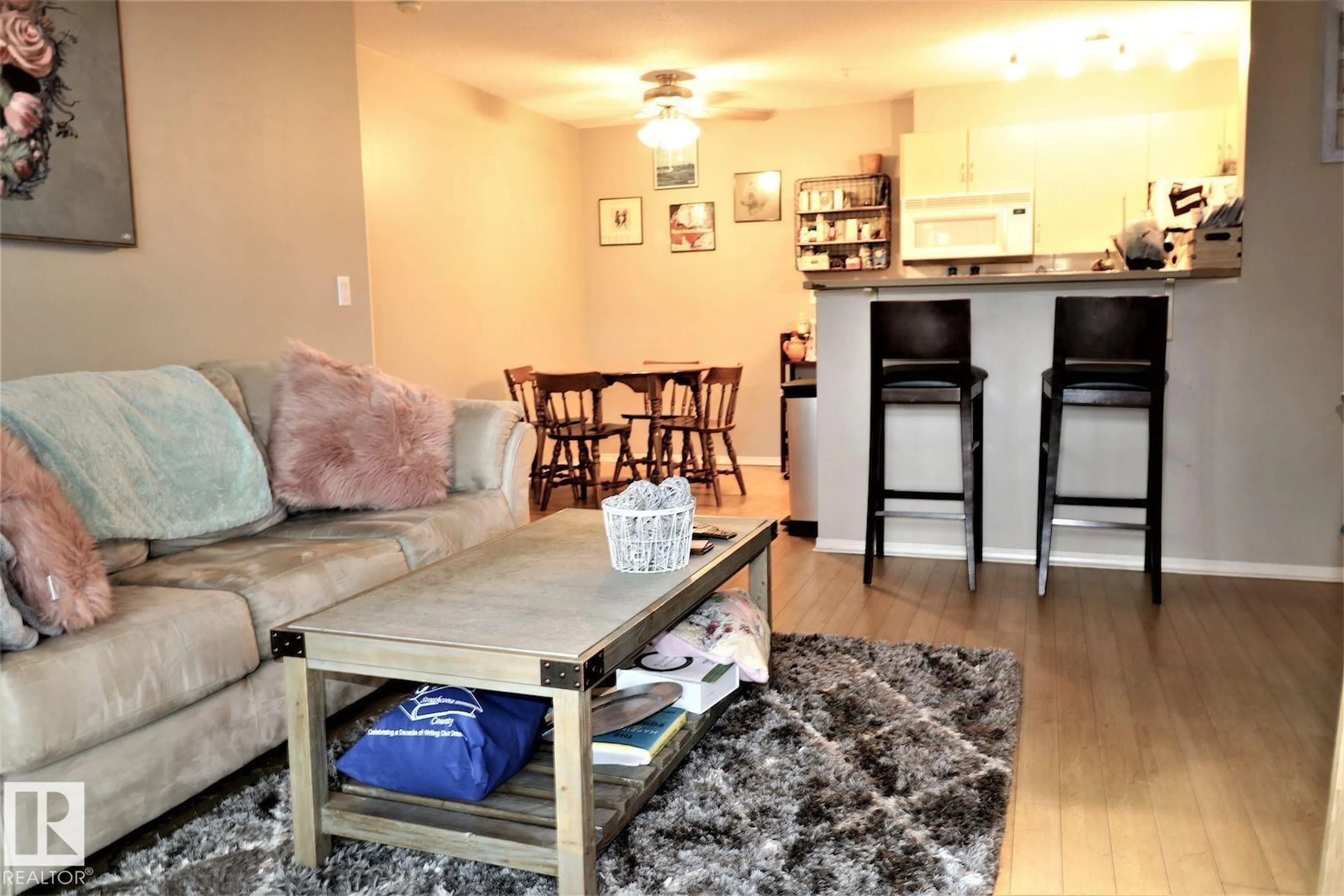 Living room with furniture, wood/laminate floor for 117 - 17003 67 AV, Edmonton Alberta T5T6Y5