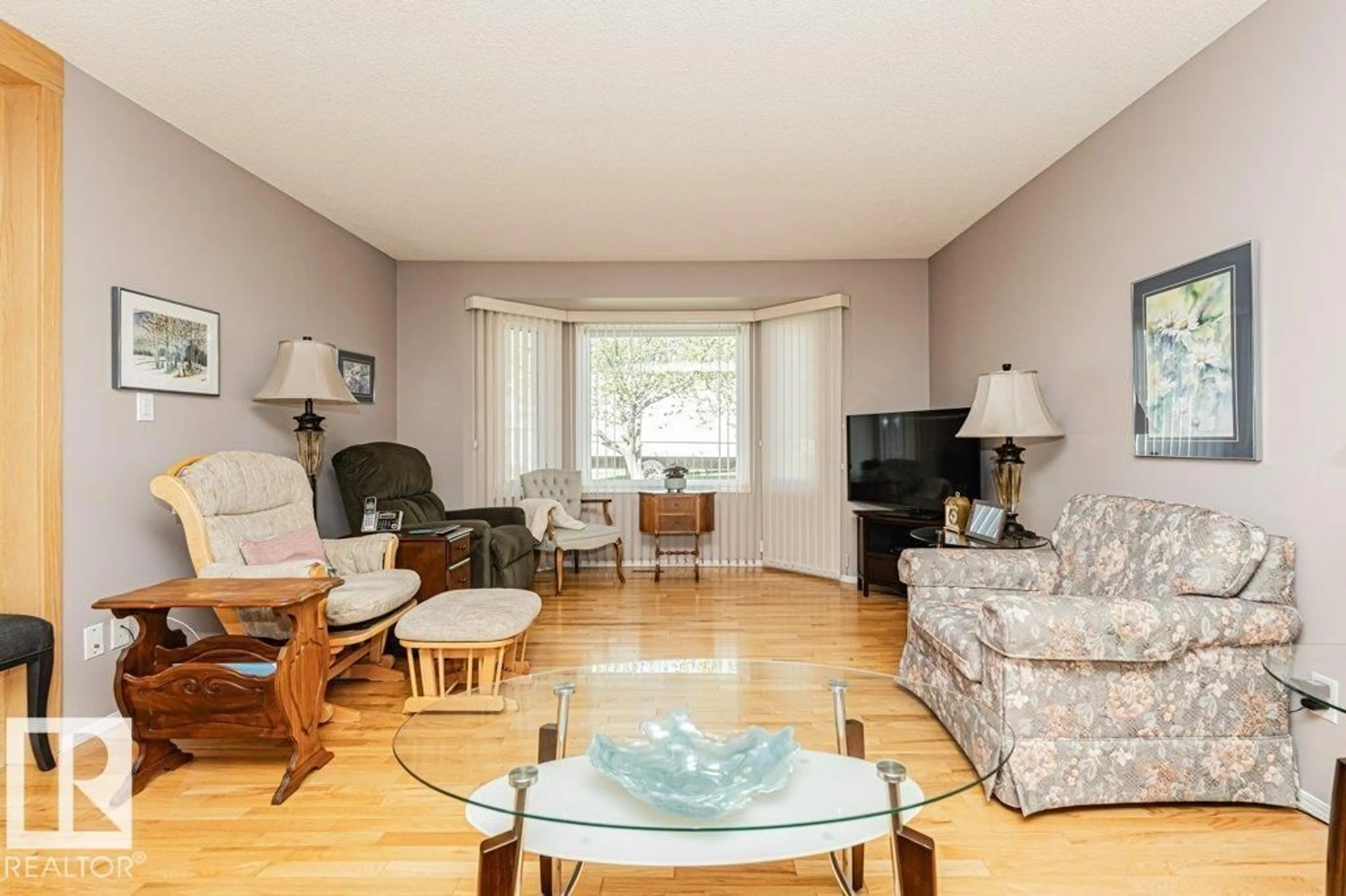 Living room with furniture, wood/laminate floor for NW - 3242 38 AV, Edmonton Alberta T6T1J3