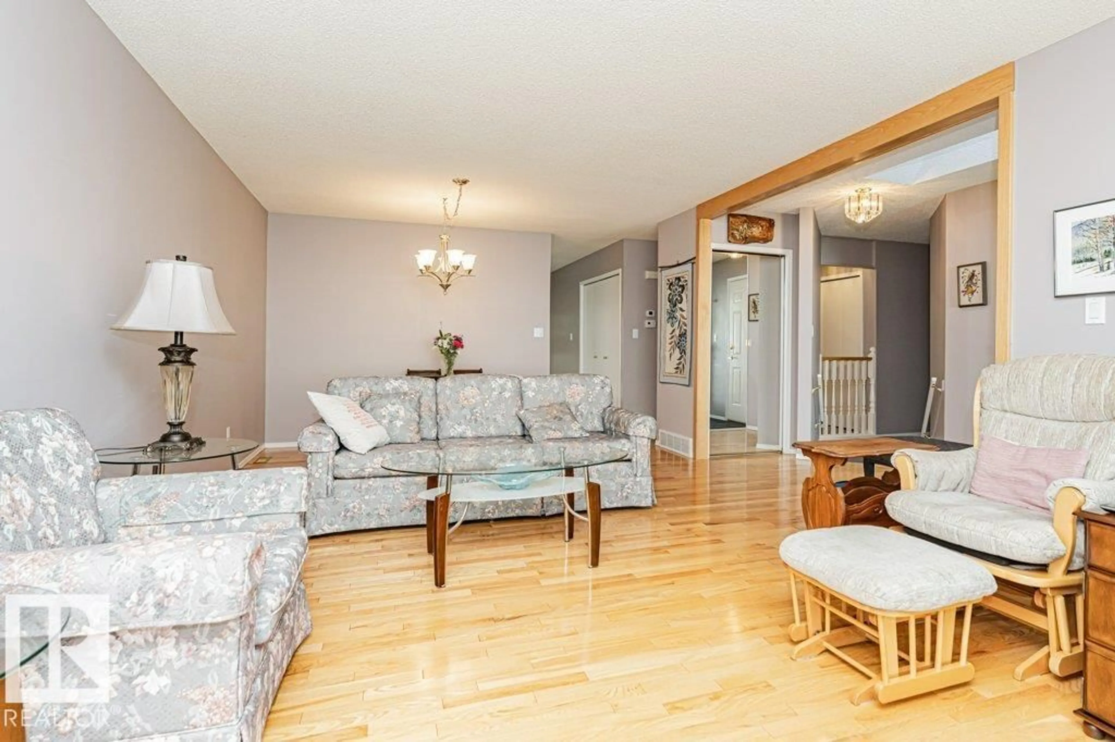 Living room with furniture, wood/laminate floor for NW - 3242 38 AV, Edmonton Alberta T6T1J3