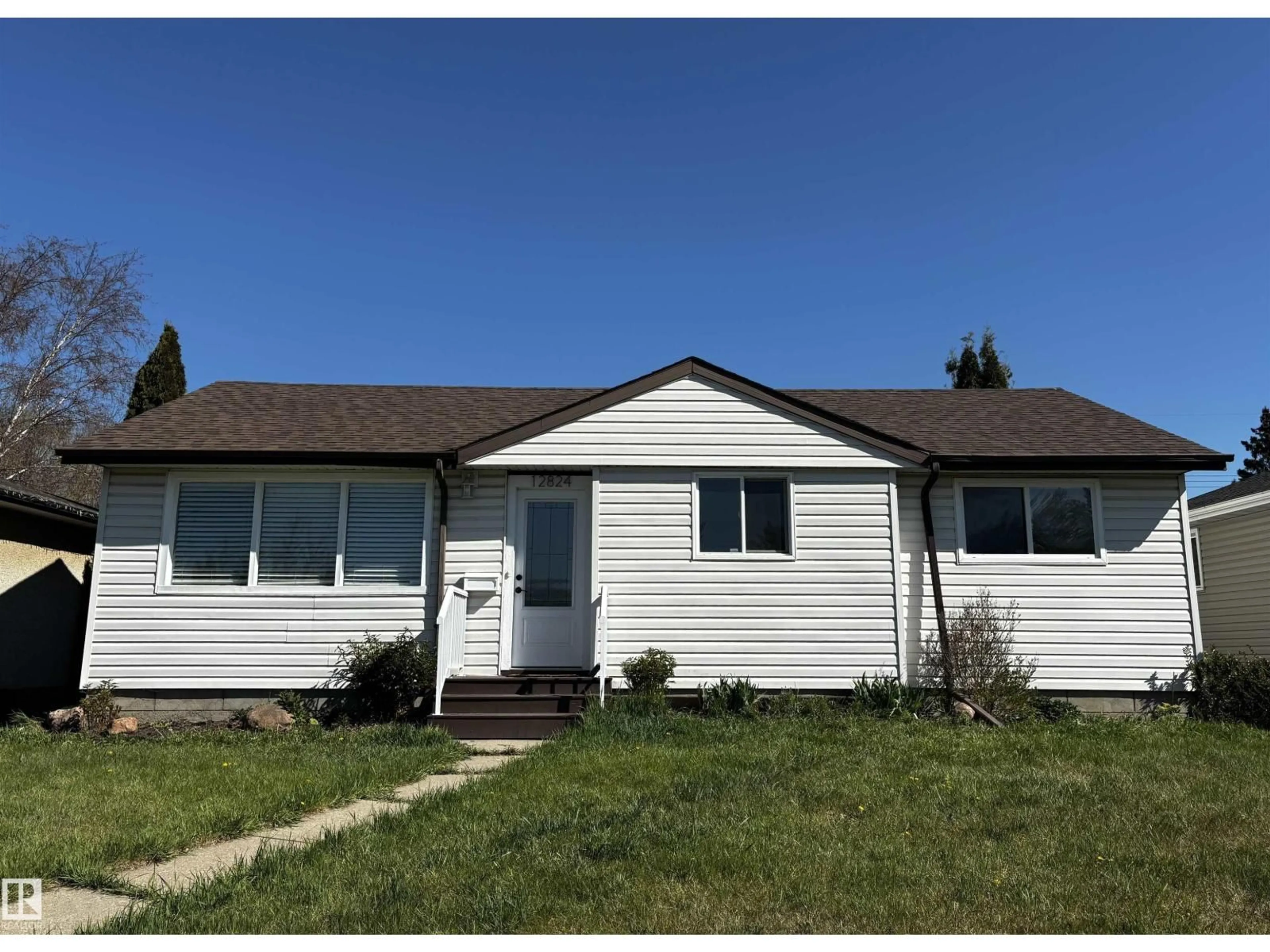 Home with vinyl exterior material, street for 12824 134 AV, Edmonton Alberta T5L3V5