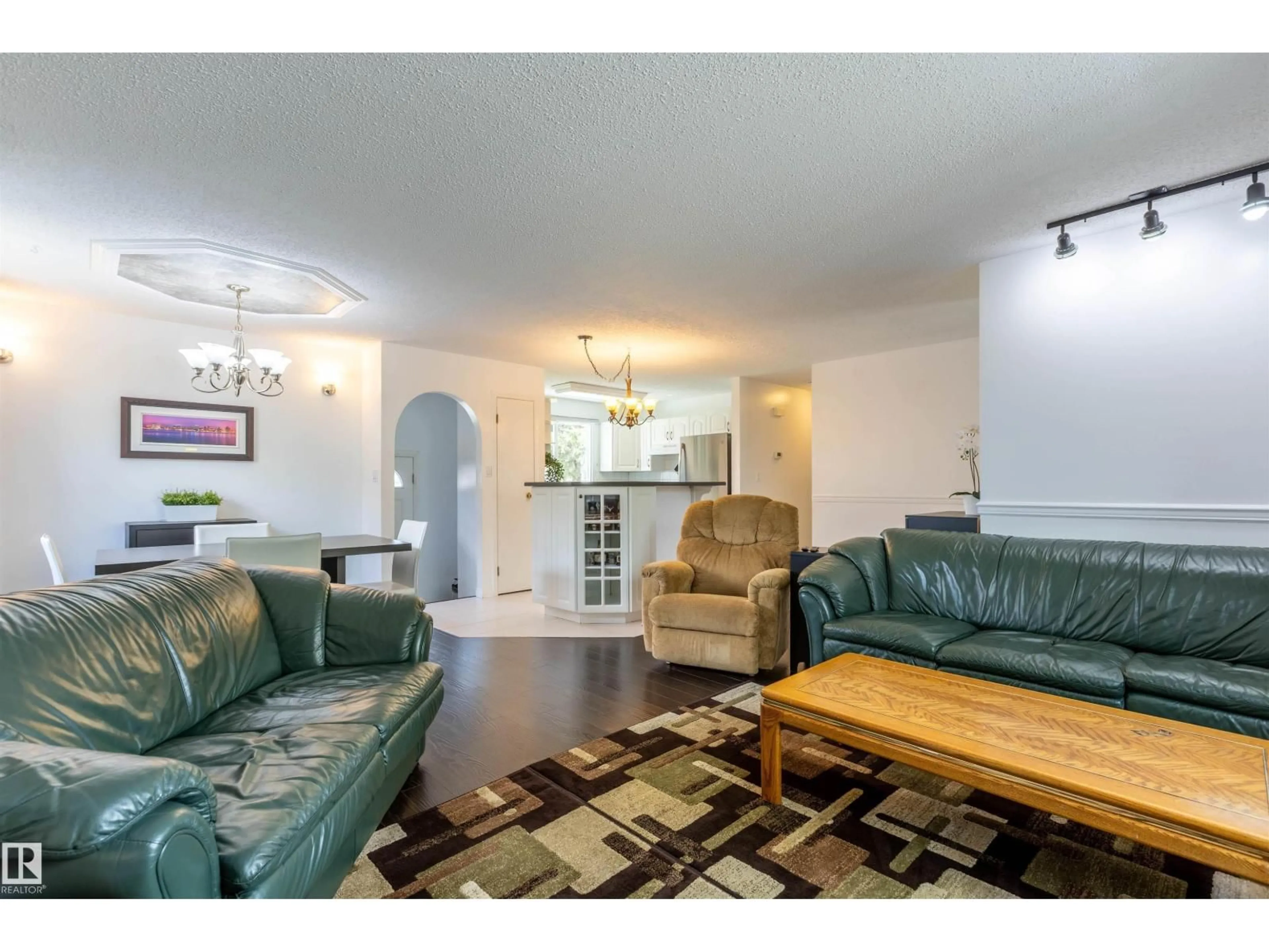 Living room with furniture, wood/laminate floor for 722 GRANDIN DR, Morinville Alberta T8R1K2