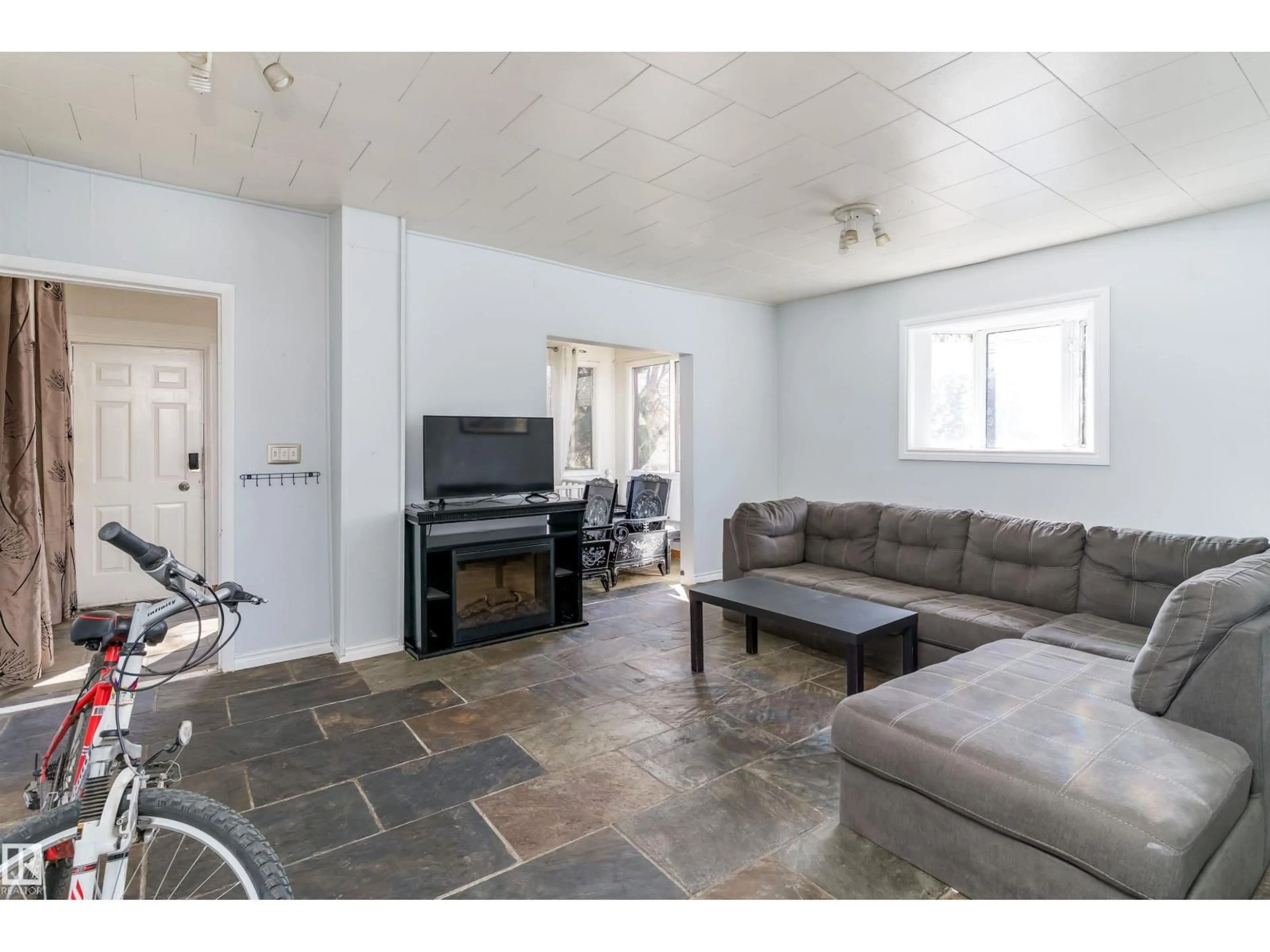 Living room with furniture, ceramic/tile floor for 12770 117 ST, Edmonton Alberta T5E5J5