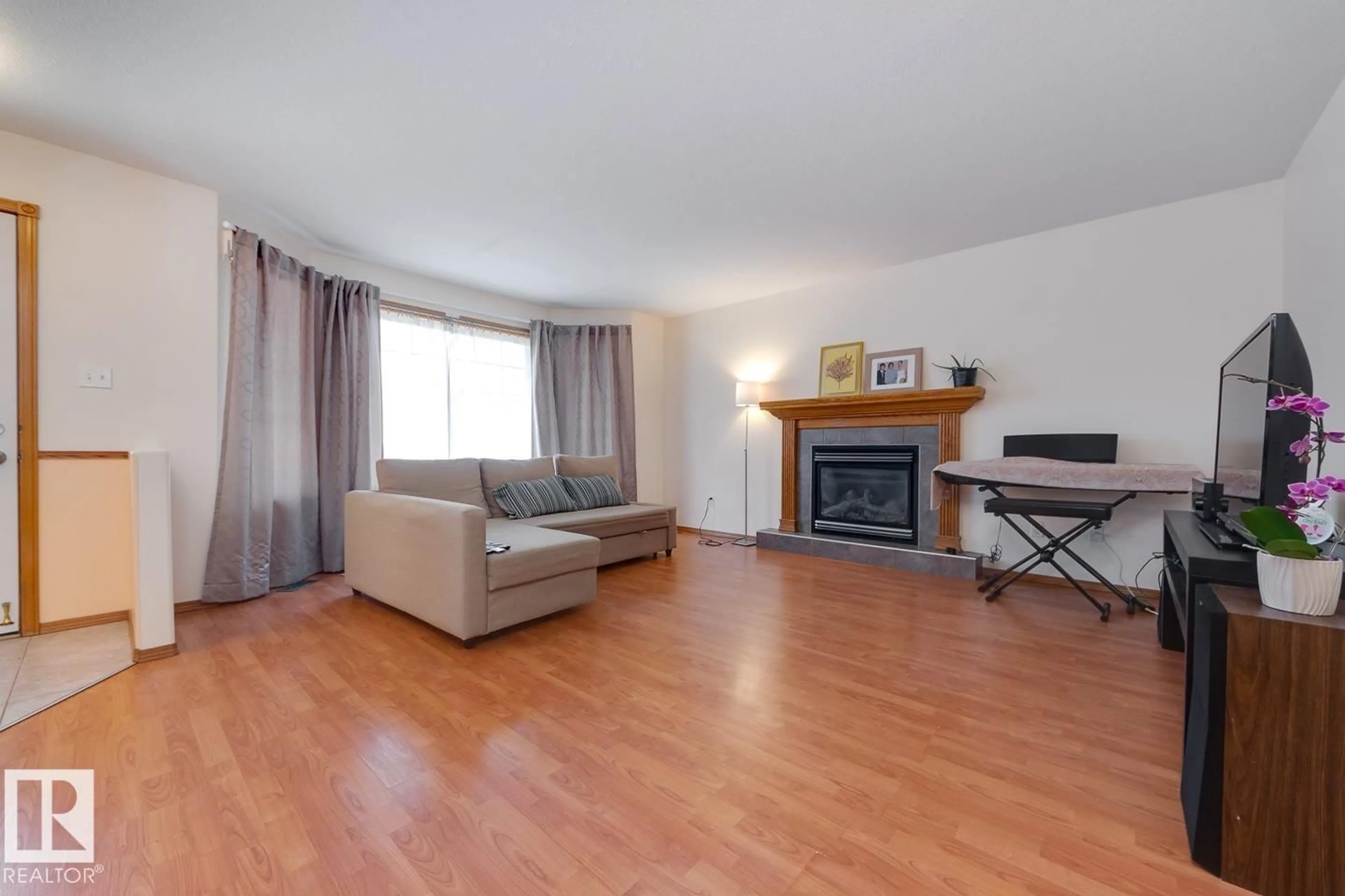 Living room with furniture, wood/laminate floor for 10816 67 AV, Edmonton Alberta T6H2A3