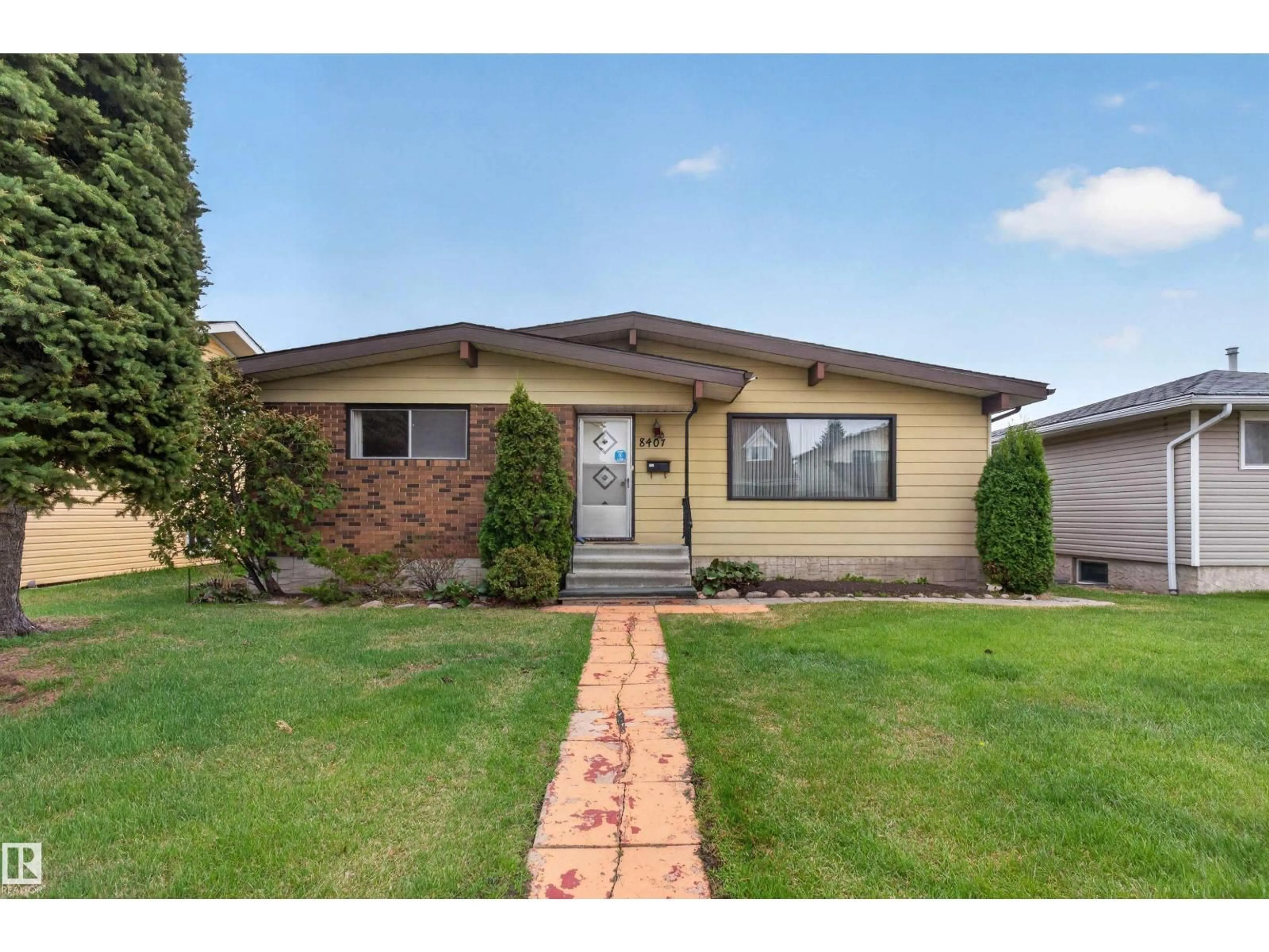 Home with vinyl exterior material, street for 8407 150 AV, Edmonton Alberta T5E1B9