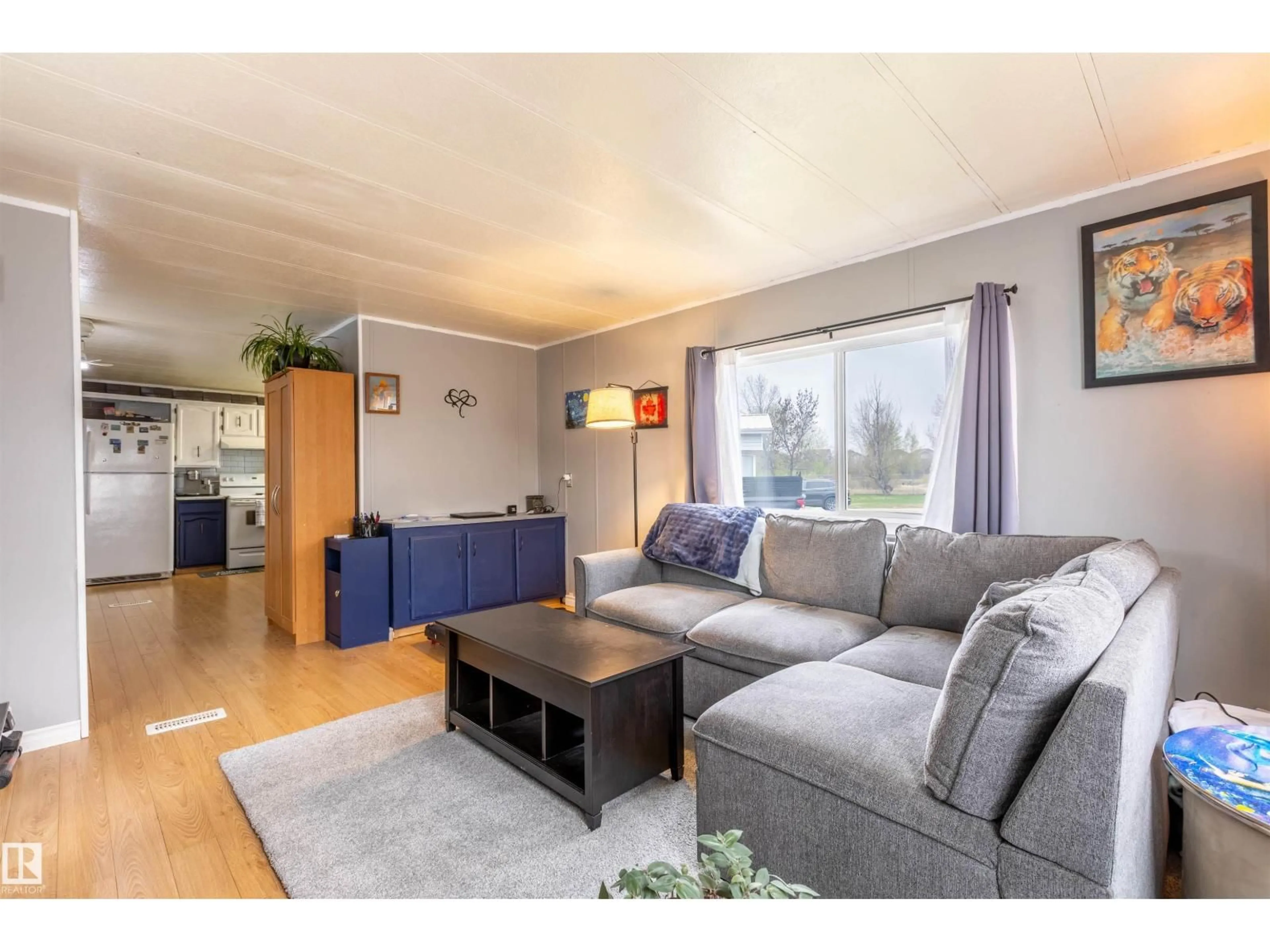 Living room with furniture, wood/laminate floor for 62 10401 101A ST, Morinville Alberta T8R1B2