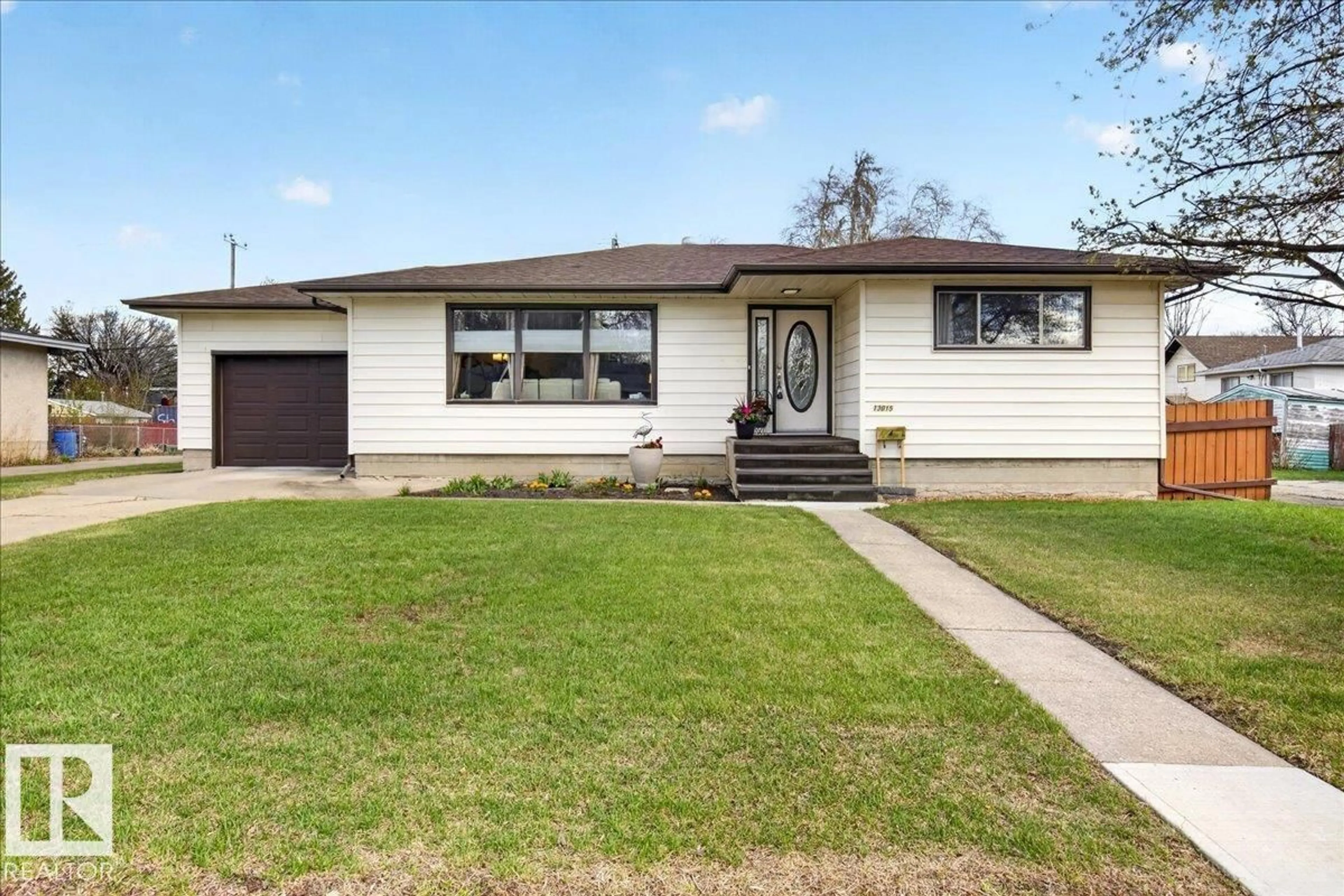 Home with vinyl exterior material, street for NW - 13015 115 ST, Edmonton Alberta T5E5G4