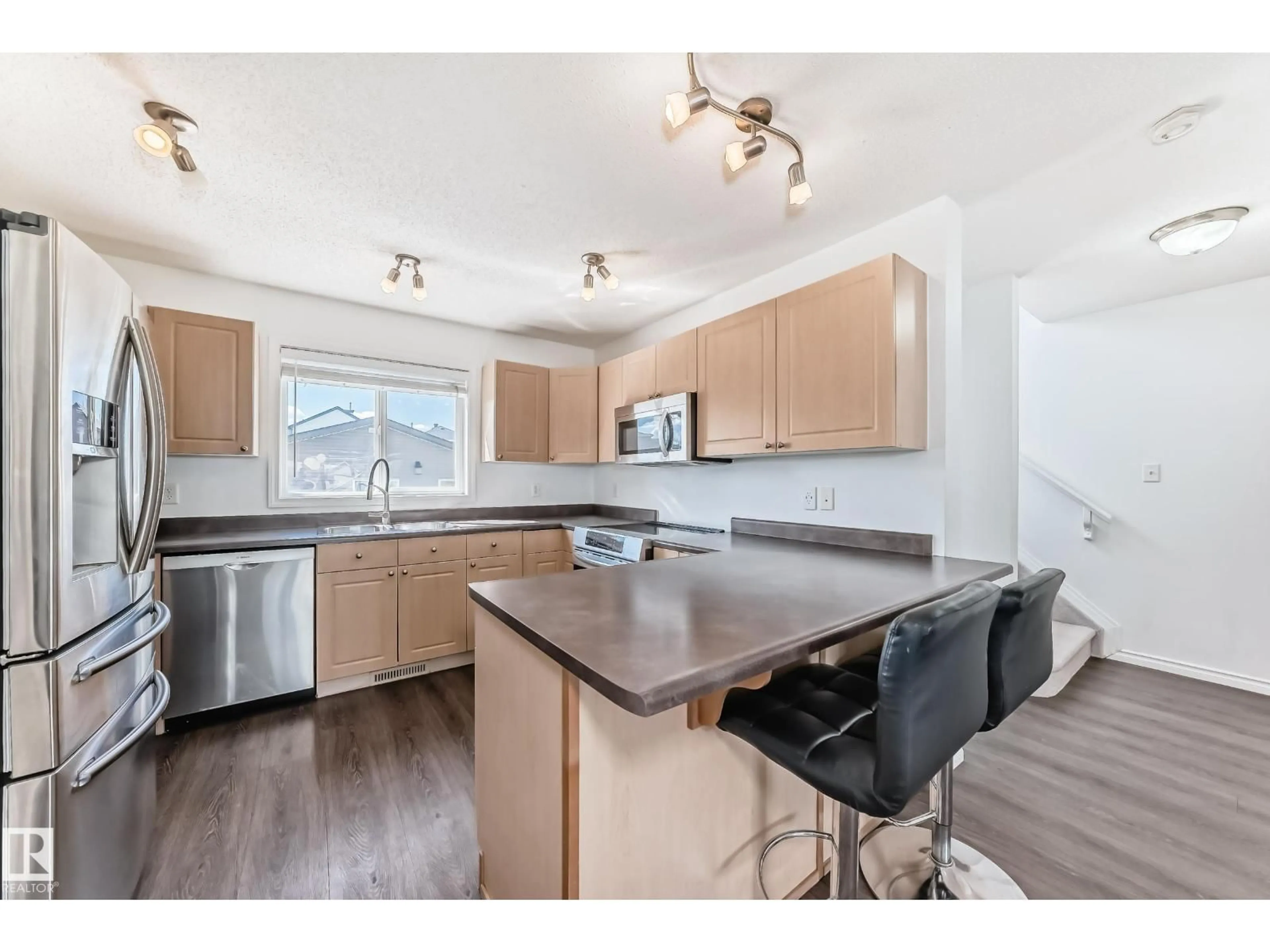 Open concept kitchen, wood/laminate floor for 2339 28B AVE AV, Edmonton Alberta T6T2A4