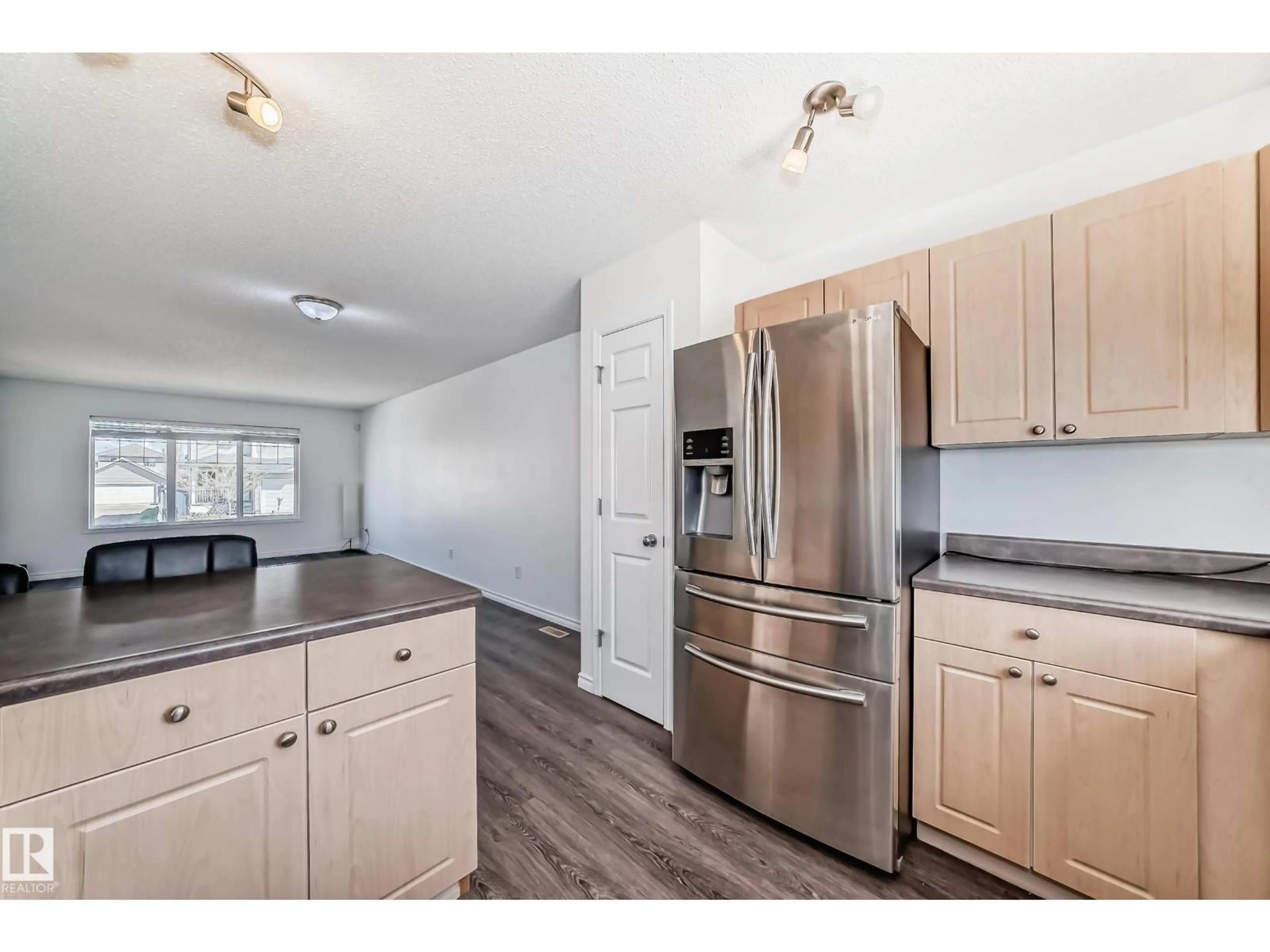 Open concept kitchen, wood/laminate floor for 2339 28B AVE AV, Edmonton Alberta T6T2A4