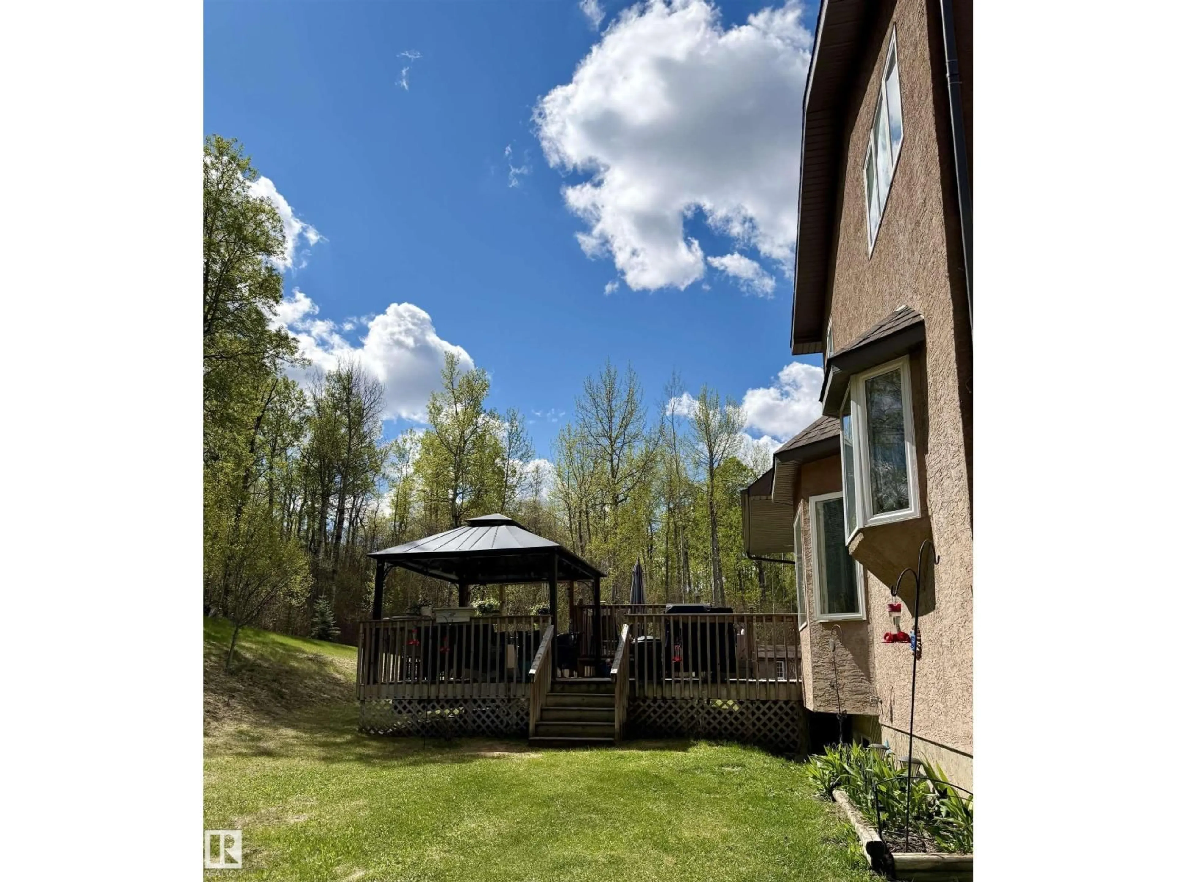A pic from outside/outdoor area/front of a property/back of a property/a pic from drone, forest/trees view for 34 - 54419 RGE ROAD 14, Rural Lac Ste. Anne County Alberta T0E1V0