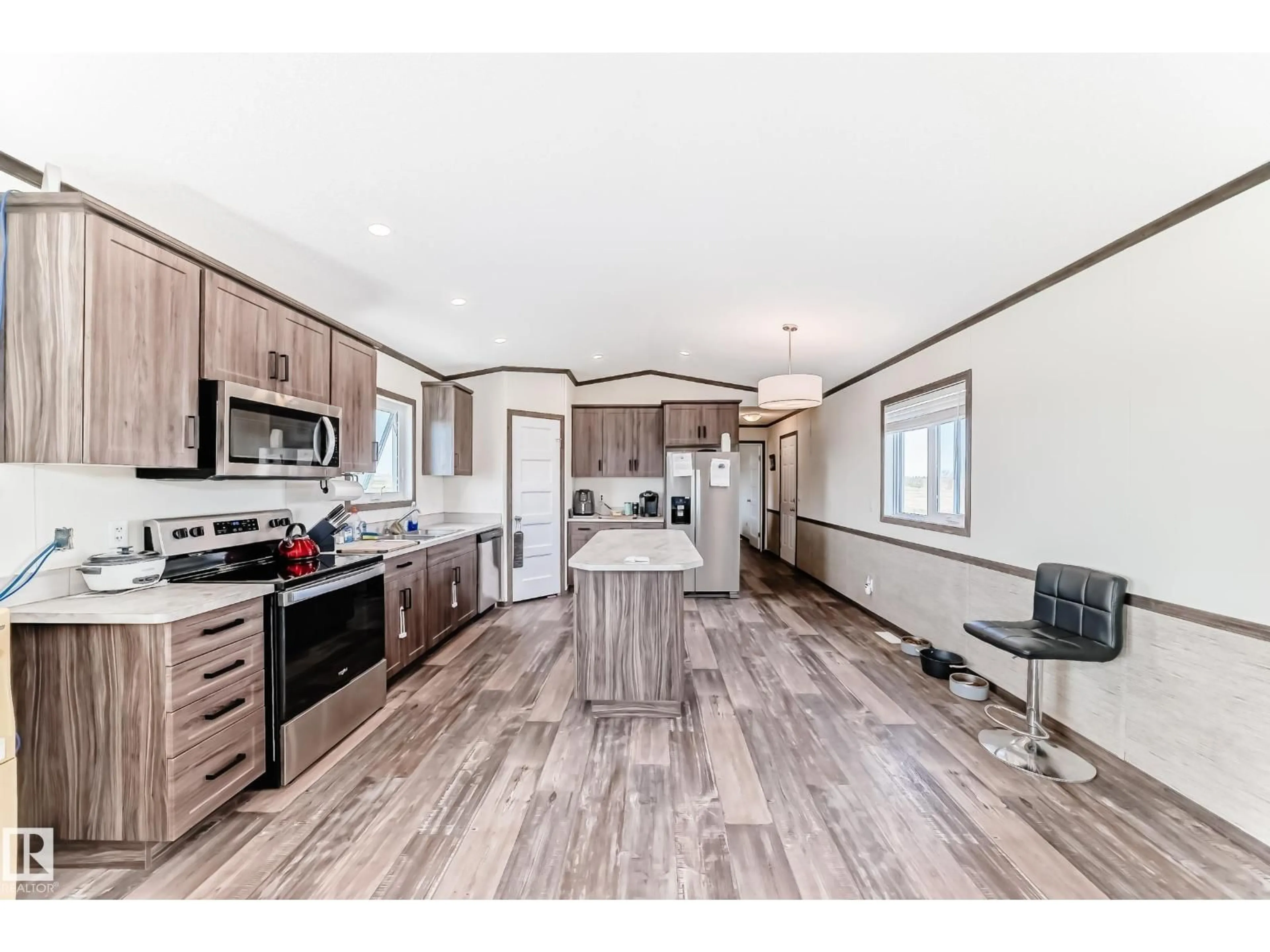 Open concept kitchen, wood/laminate floor for 56432 HWY 777, Rural Barrhead County Alberta T7N0L6