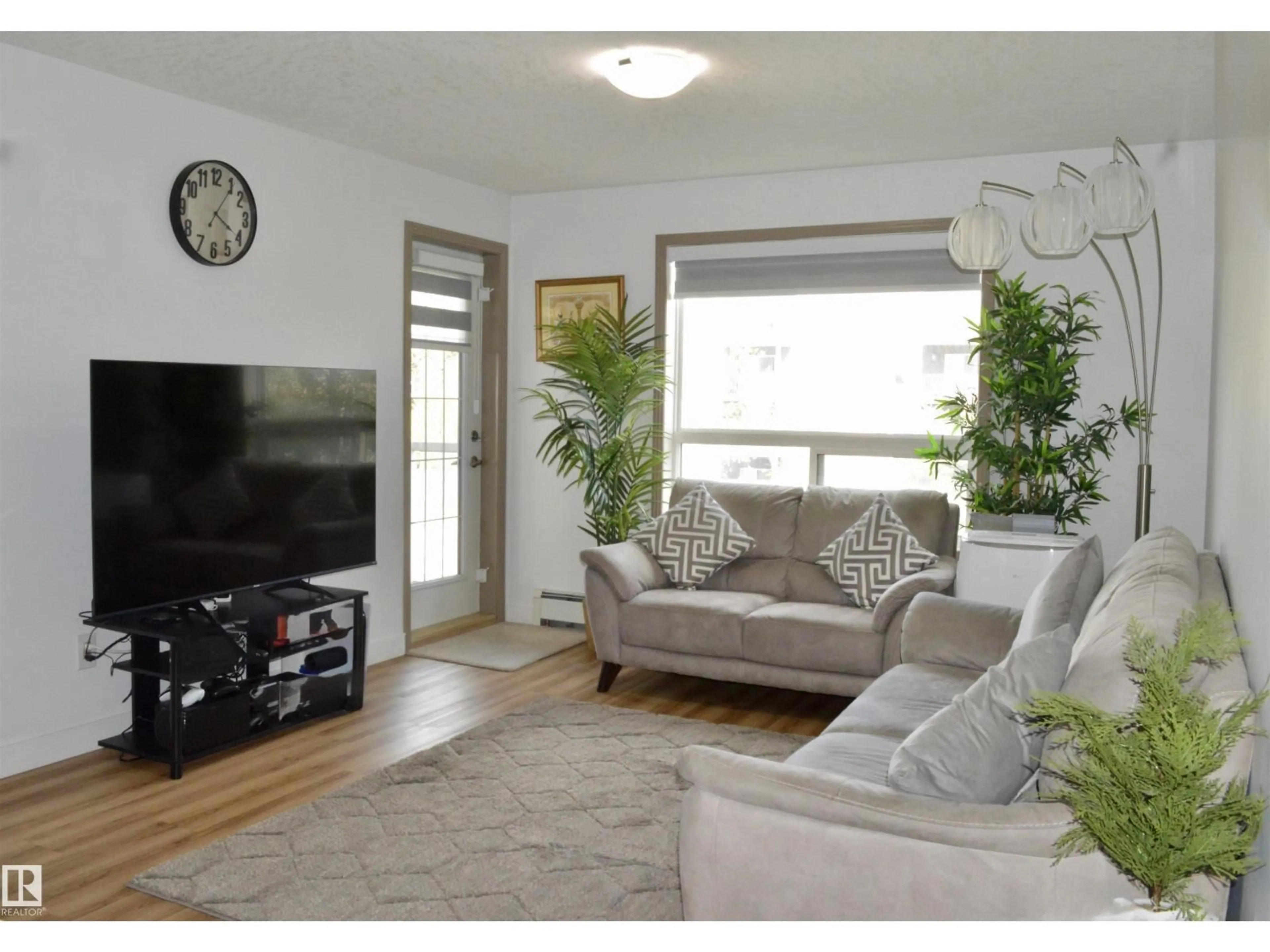 Living room with furniture, wood/laminate floor for 210 - 5005 165 AV, Edmonton Alberta T5Y0L8