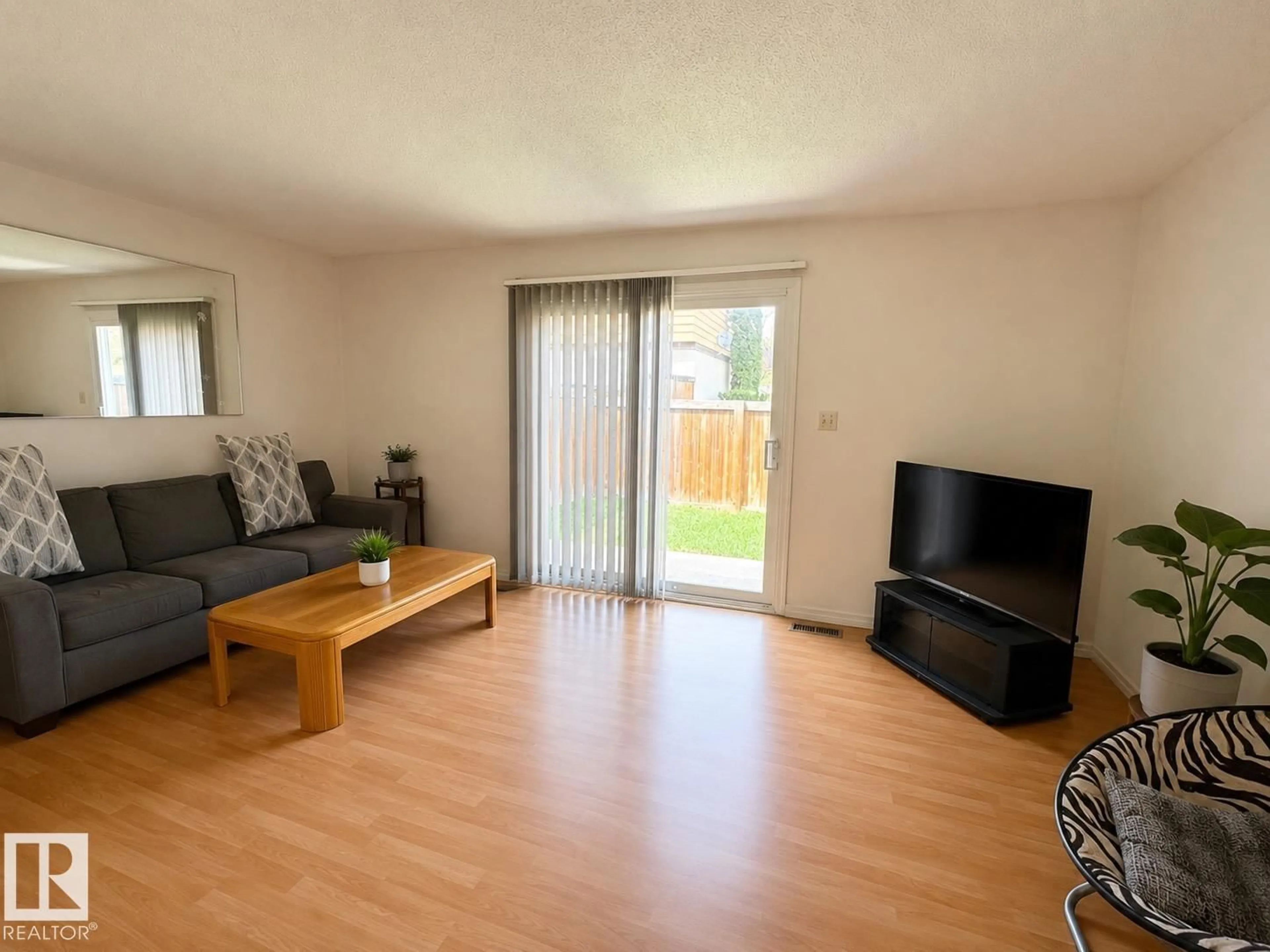 Living room with furniture, wood/laminate floor for 126 WOODSTOCK NW, Edmonton Alberta T5T0H6