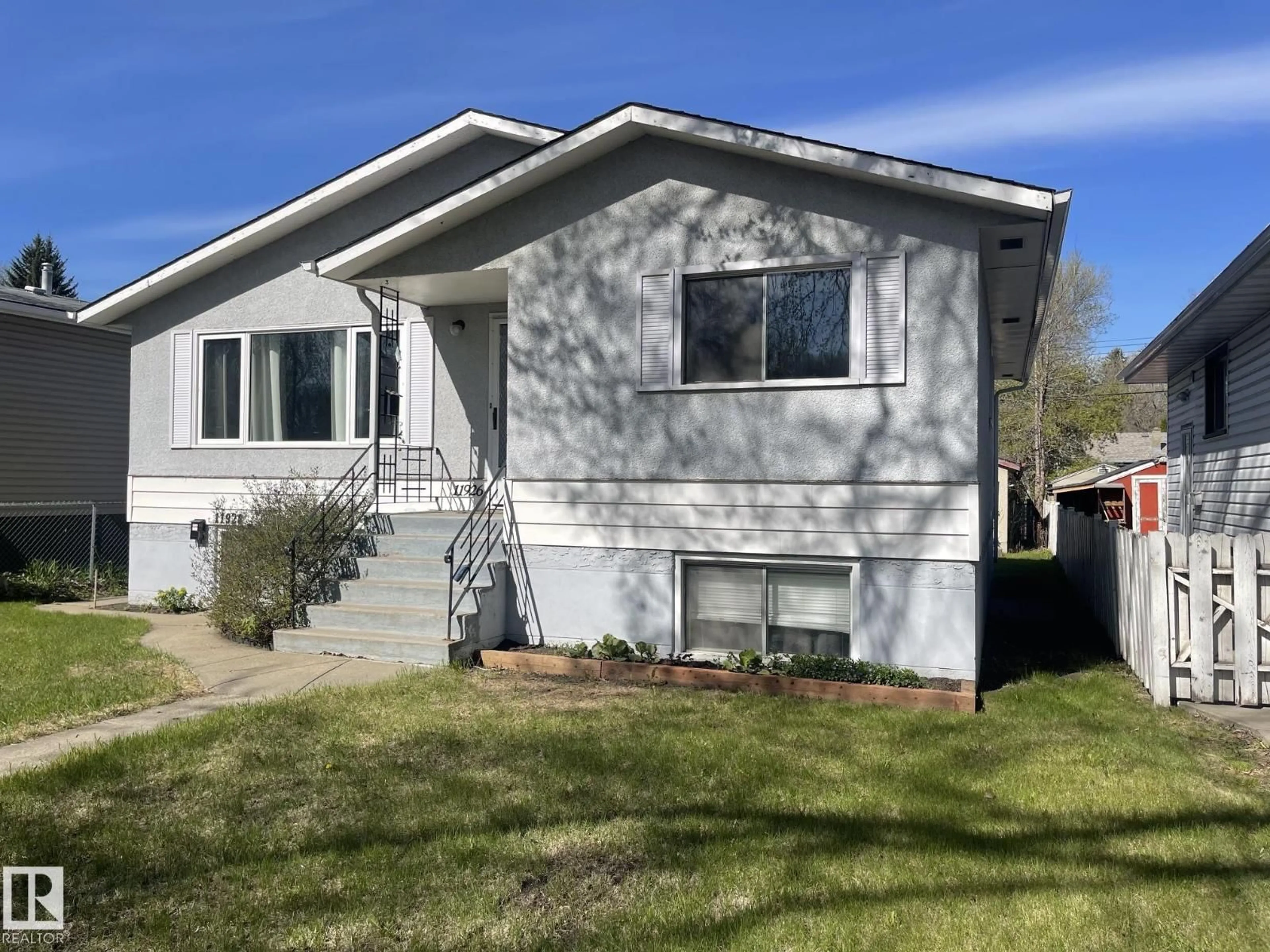 Home with vinyl exterior material, street for NW - 11926/11928 56 ST, Edmonton Alberta T5W3S9
