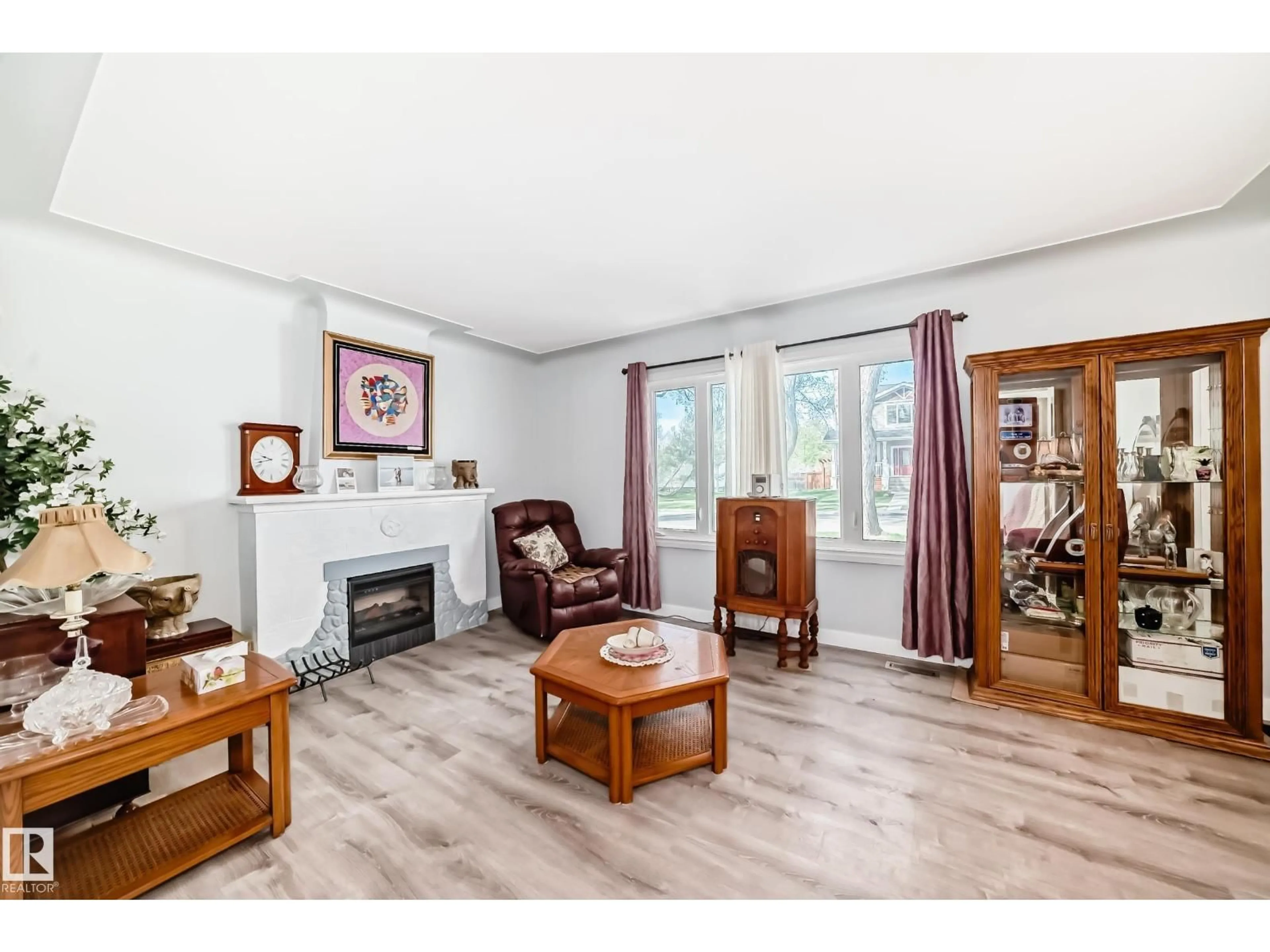 Living room with furniture, wood/laminate floor for 11303 60 ST, Edmonton Alberta T5W3Z2