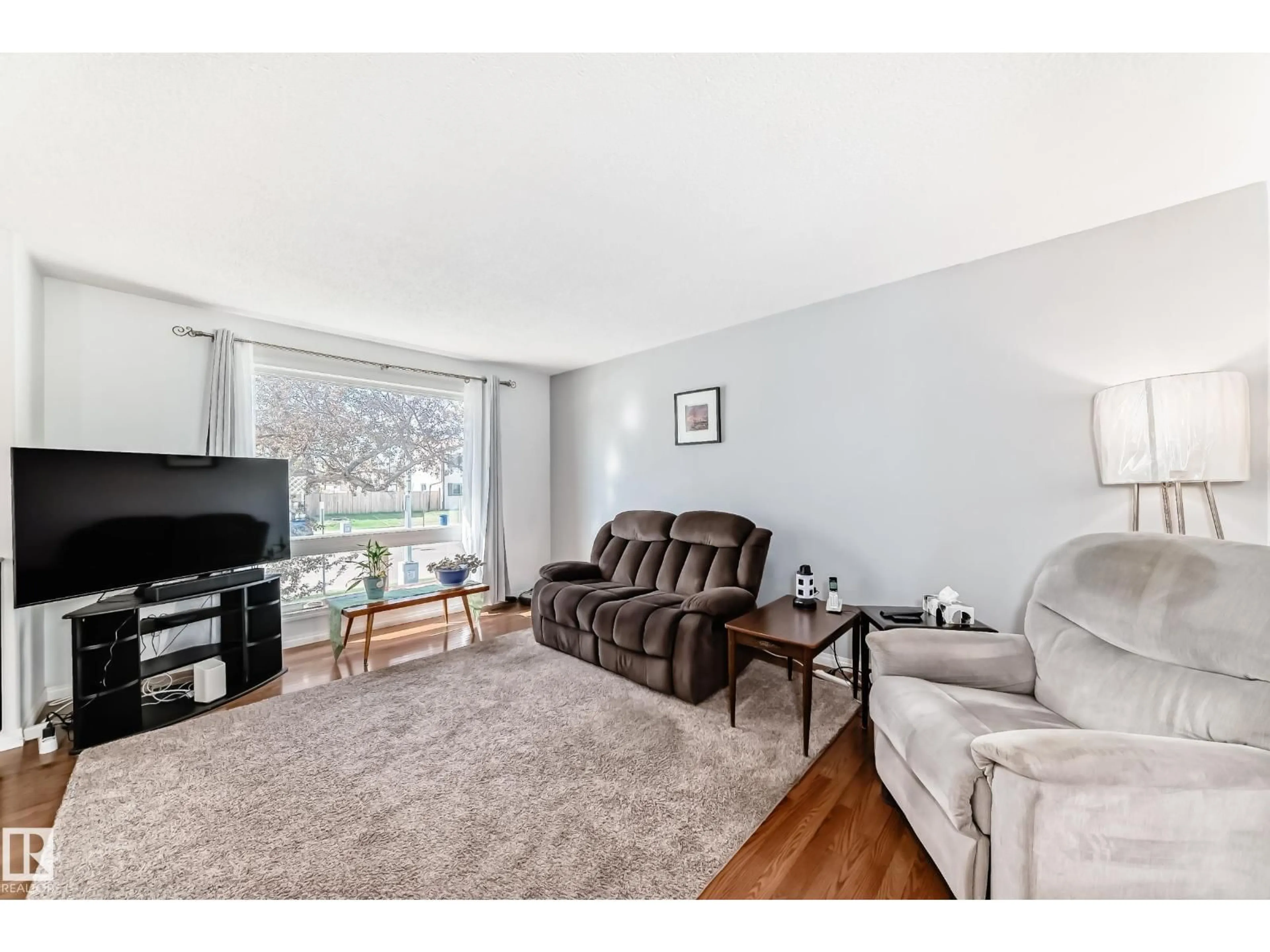 Living room with furniture, wood/laminate floor for NW - 11812 139 AV, Edmonton Alberta T5X4J5