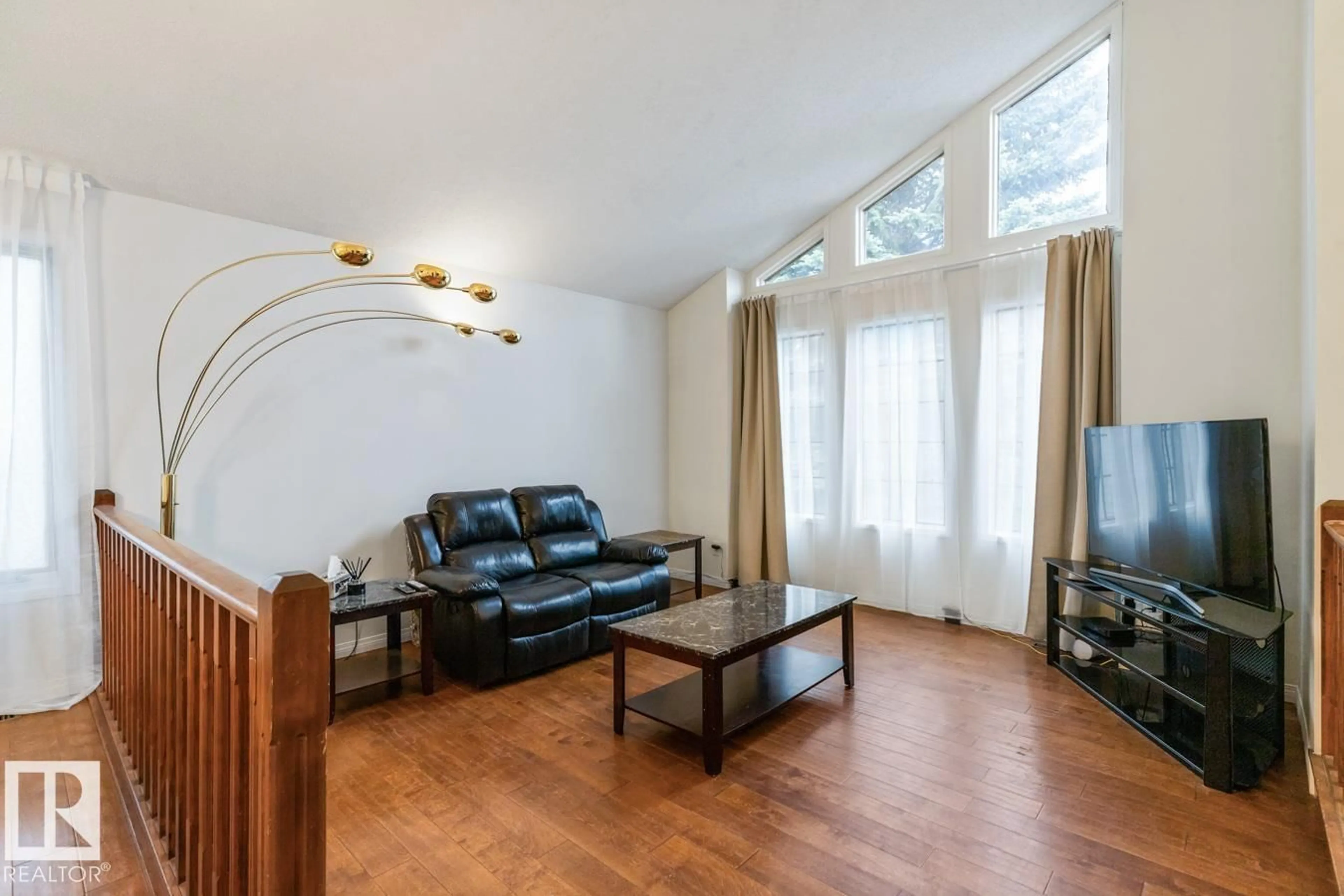 Living room with furniture, wood/laminate floor for 4340 33 ST, Edmonton Alberta T6T1B7