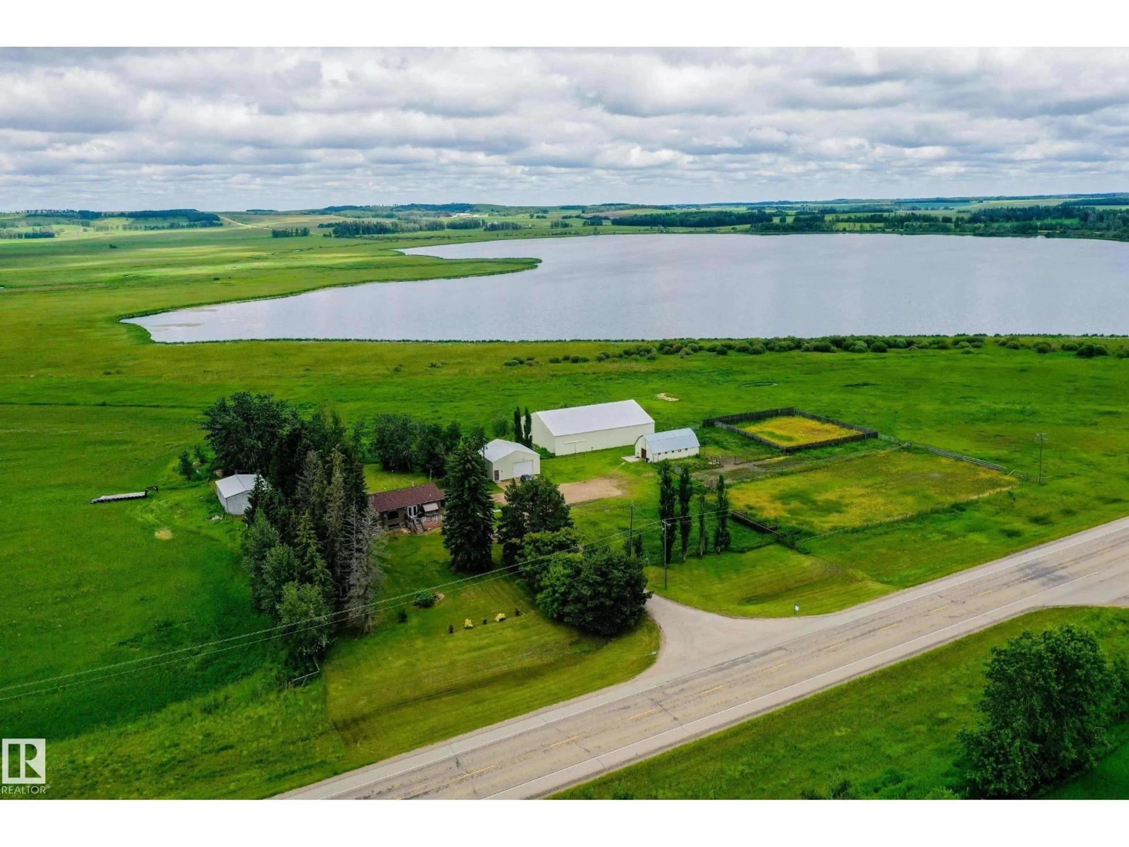 A pic from outside/outdoor area/front of a property/back of a property/a pic from drone, water/lake/river/ocean view for 280026 HWY 53, Rural Ponoka County Alberta T4J1K3