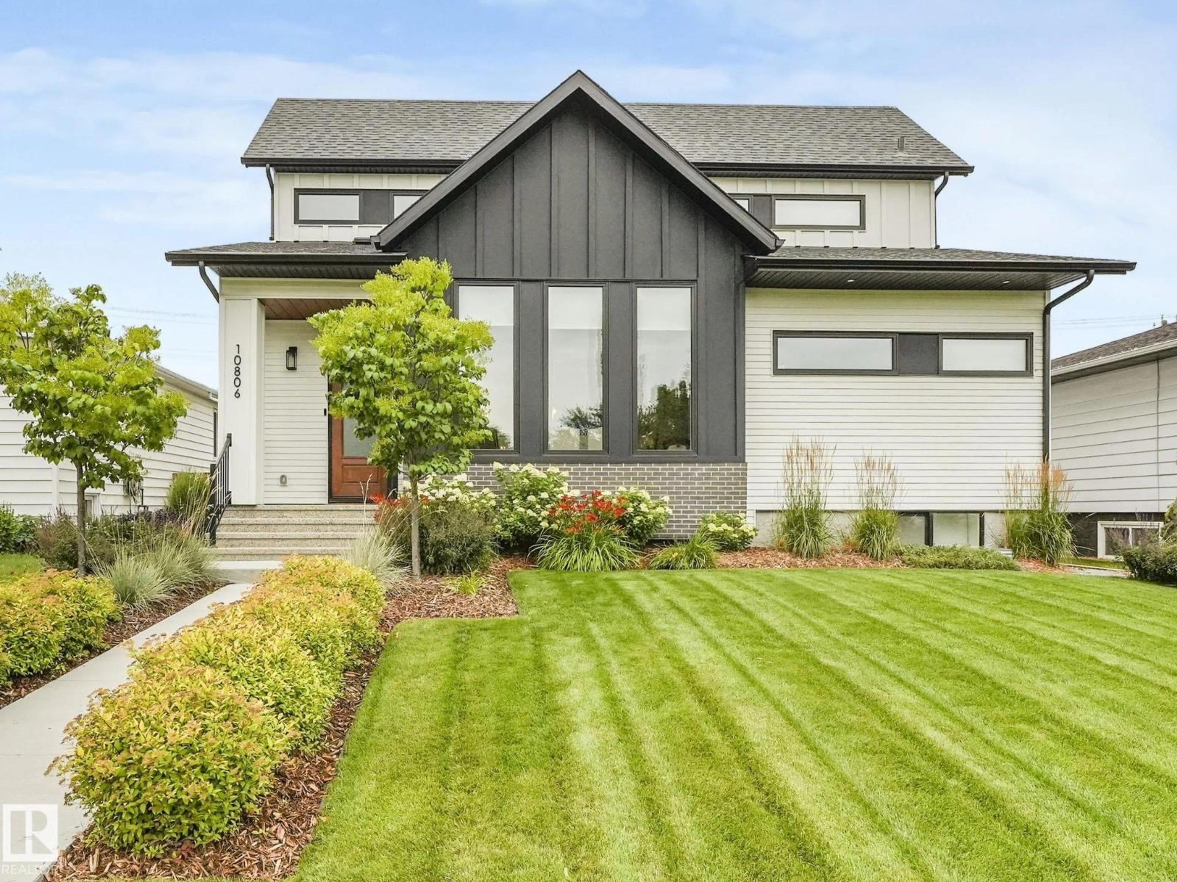 Home with vinyl exterior material, street for NW - 10806 134 ST, Edmonton Alberta T5M1H8