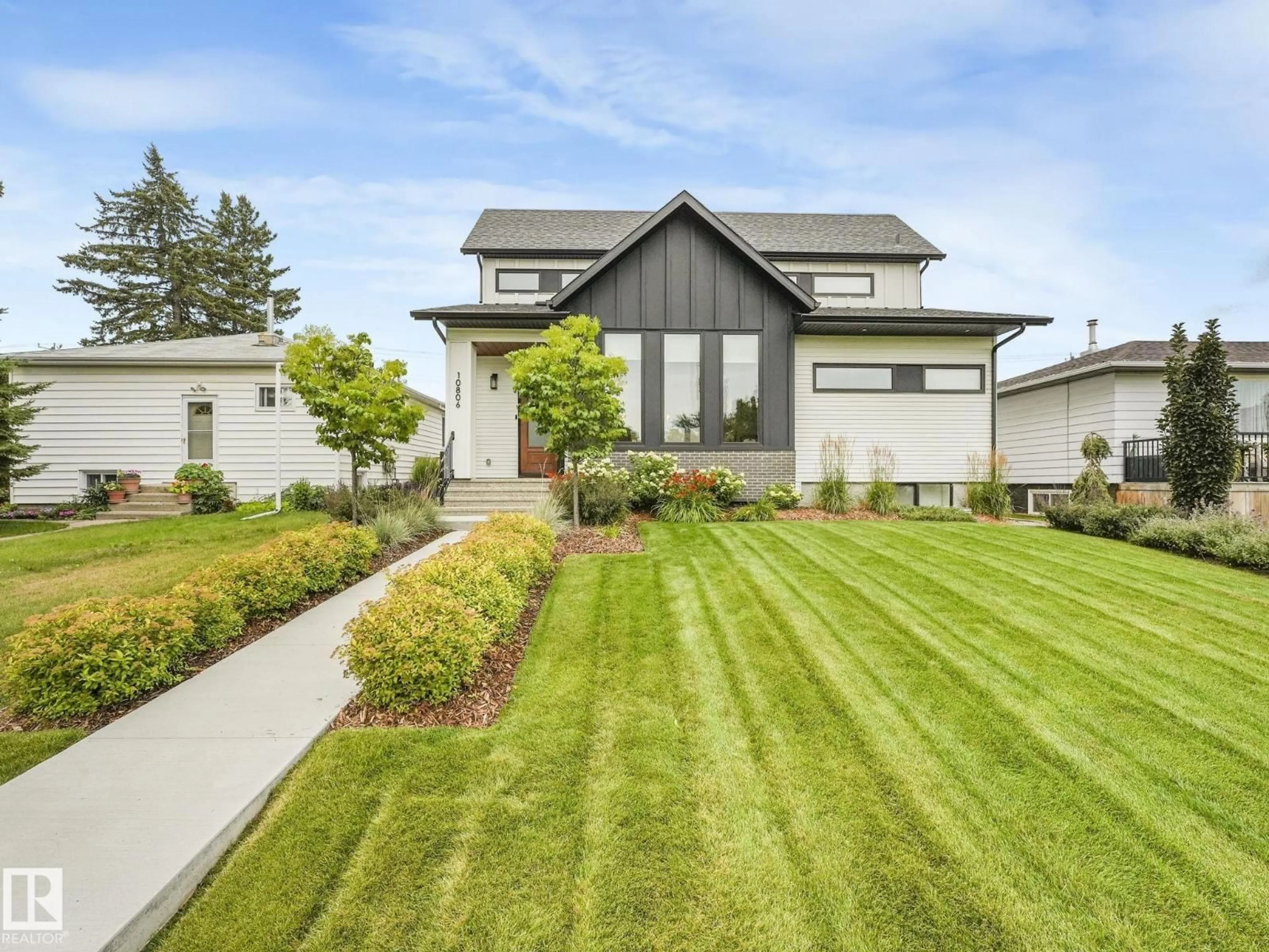 Home with vinyl exterior material, street for NW - 10806 134 ST, Edmonton Alberta T5M1H8