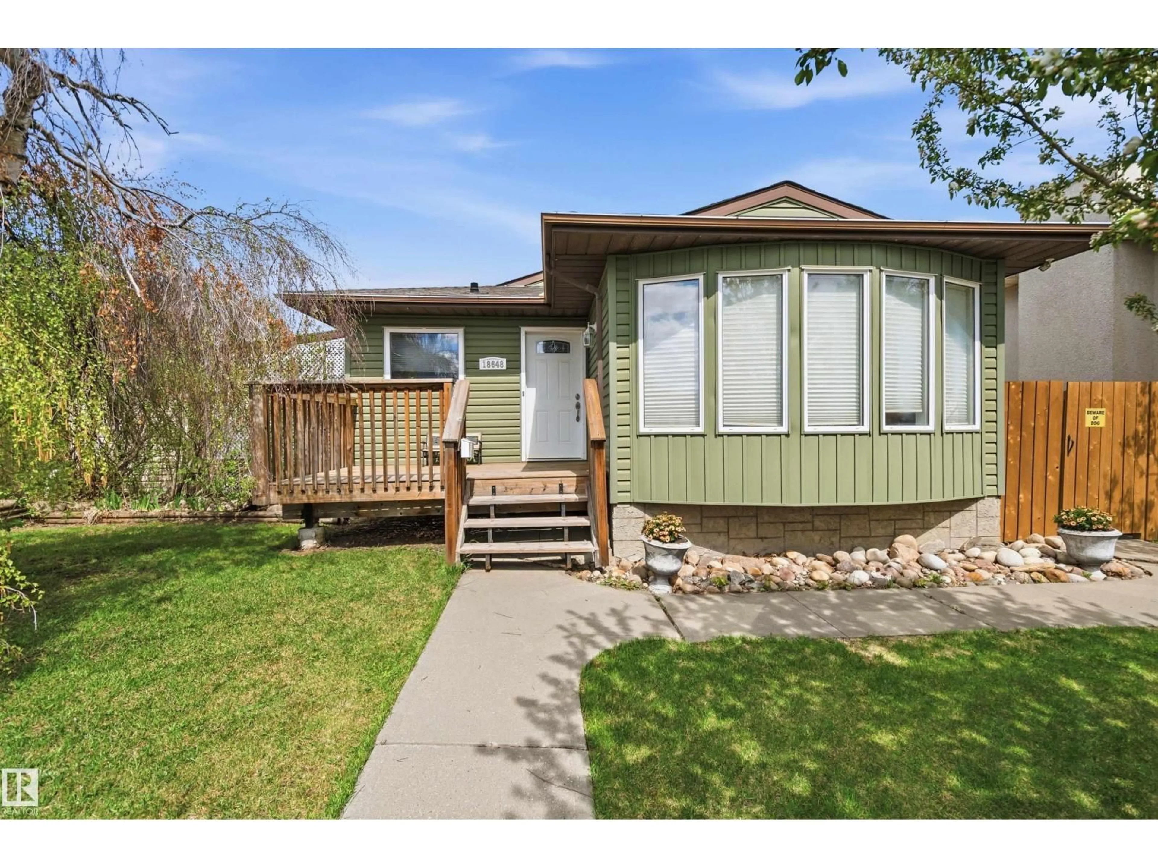 Home with vinyl exterior material, street for 18648 57 AV, Edmonton Alberta T6M2A5