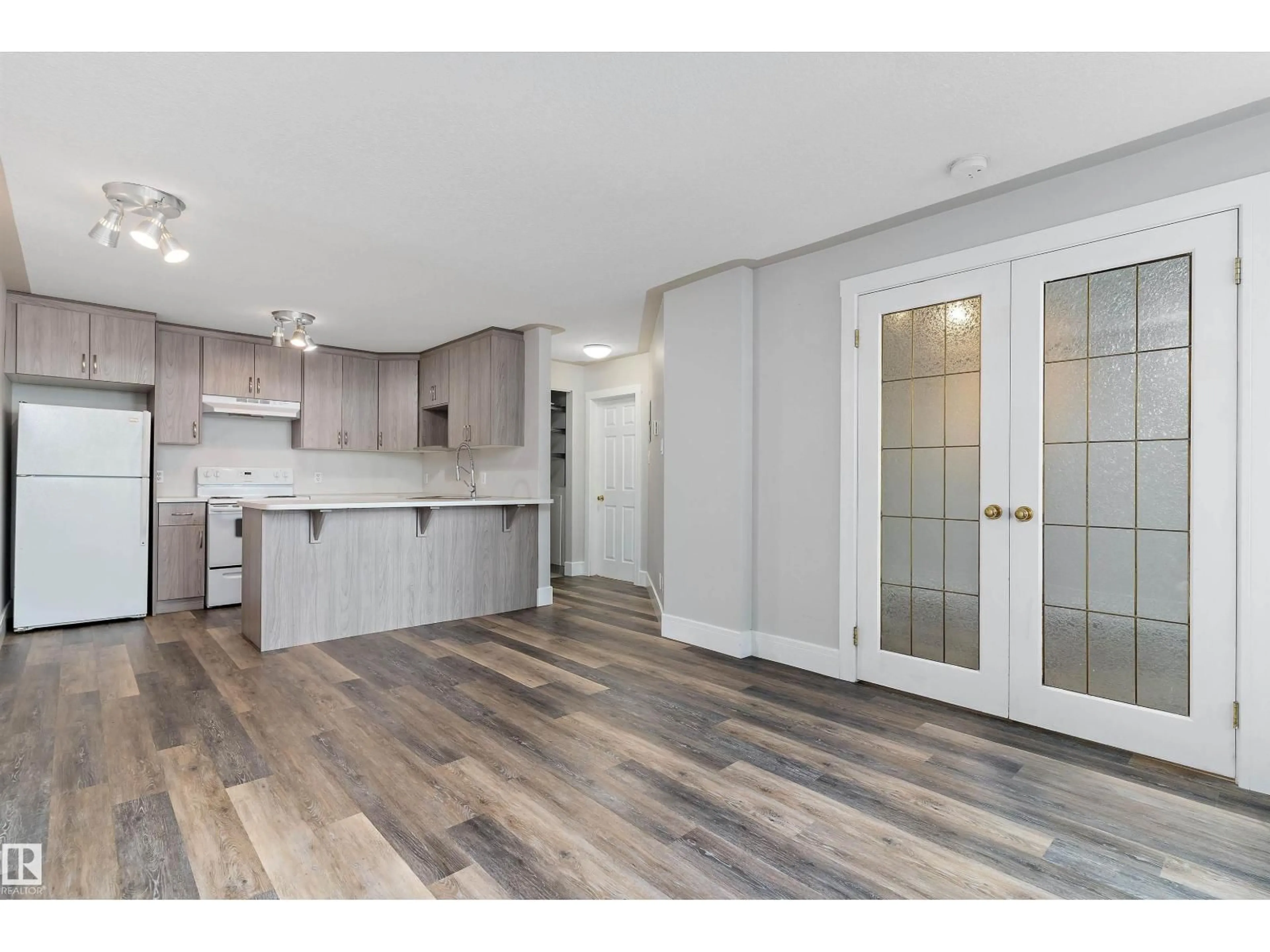 Open concept kitchen, wood/laminate floor for #7 - 11008 124 ST, Edmonton Alberta T5M0J4
