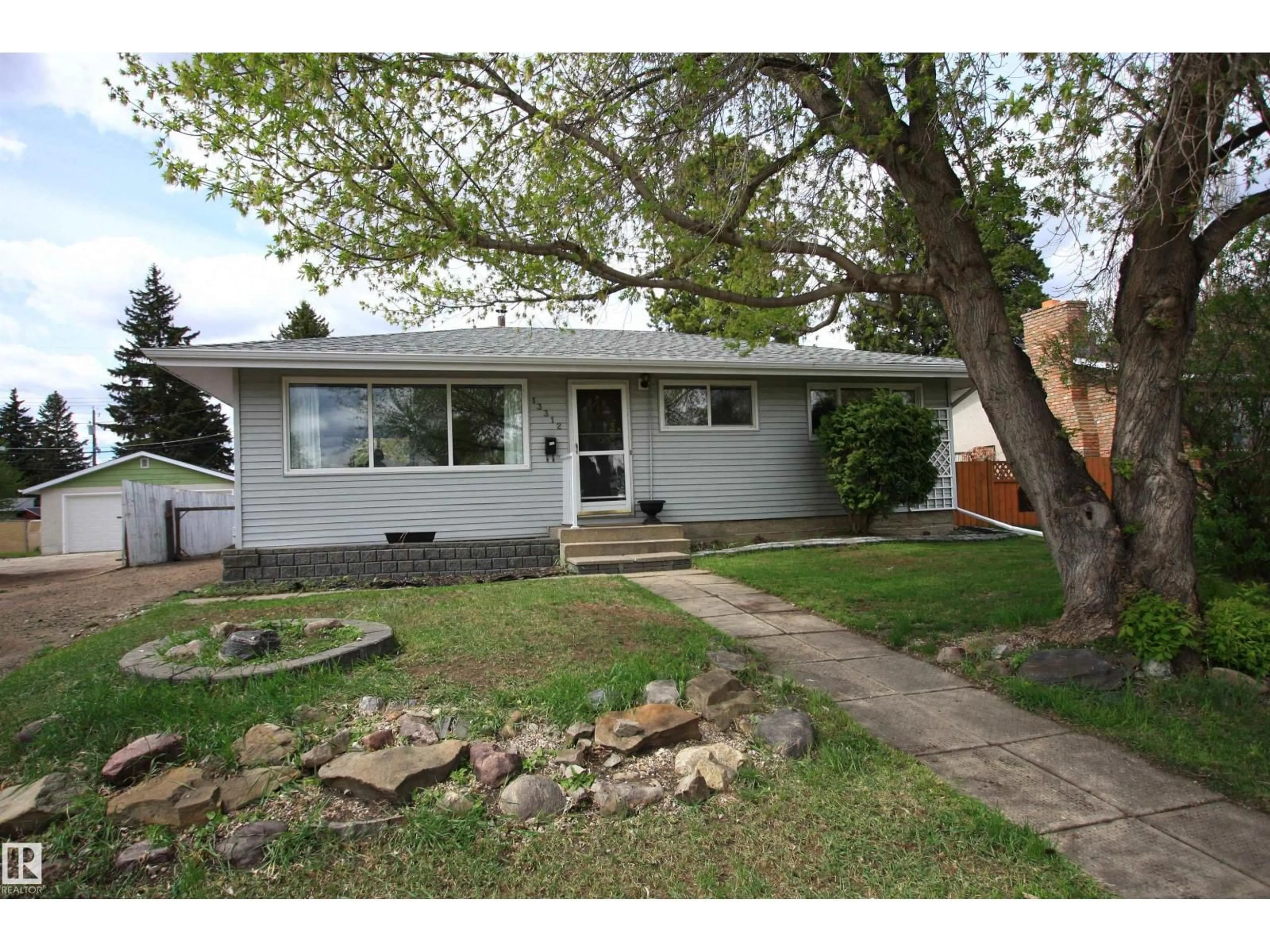 Home with vinyl exterior material, street for 13312 137 ST, Edmonton Alberta T5L2A9
