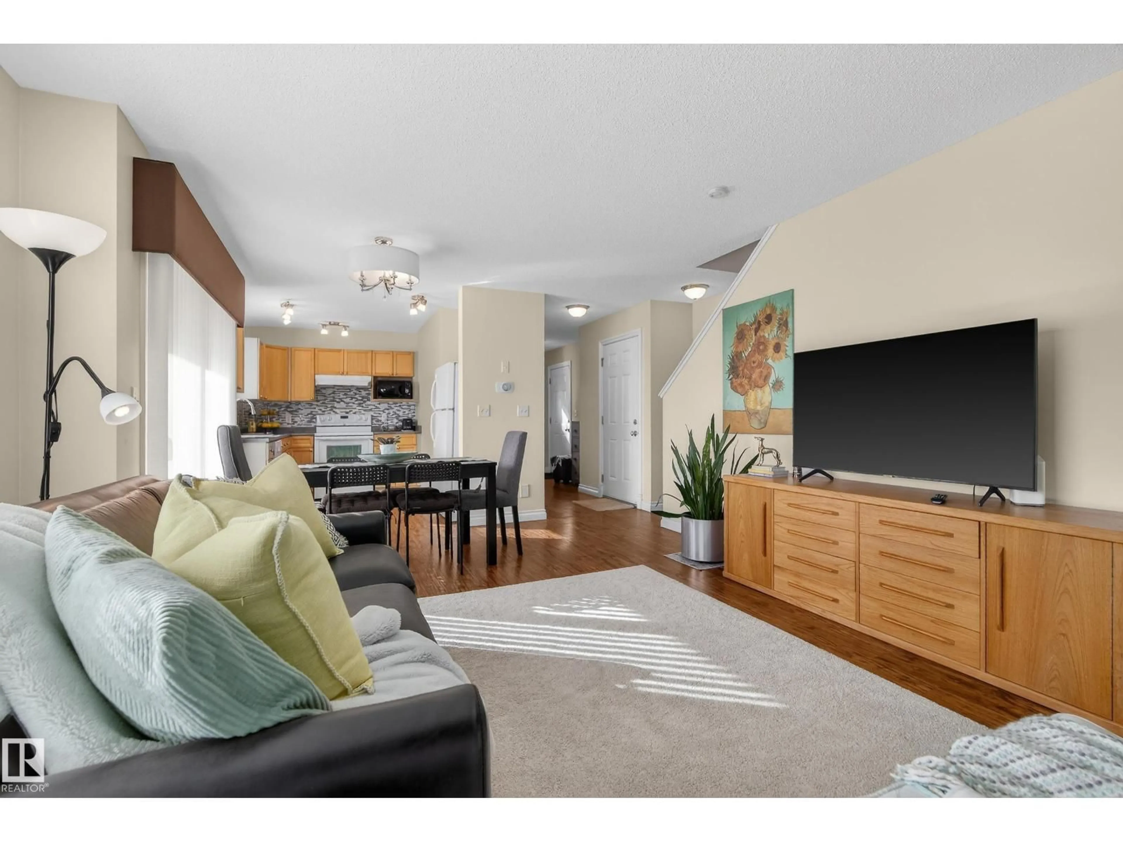 Living room with furniture, wood/laminate floor for 88 - 12050 17 AV, Edmonton Alberta T6W1X4