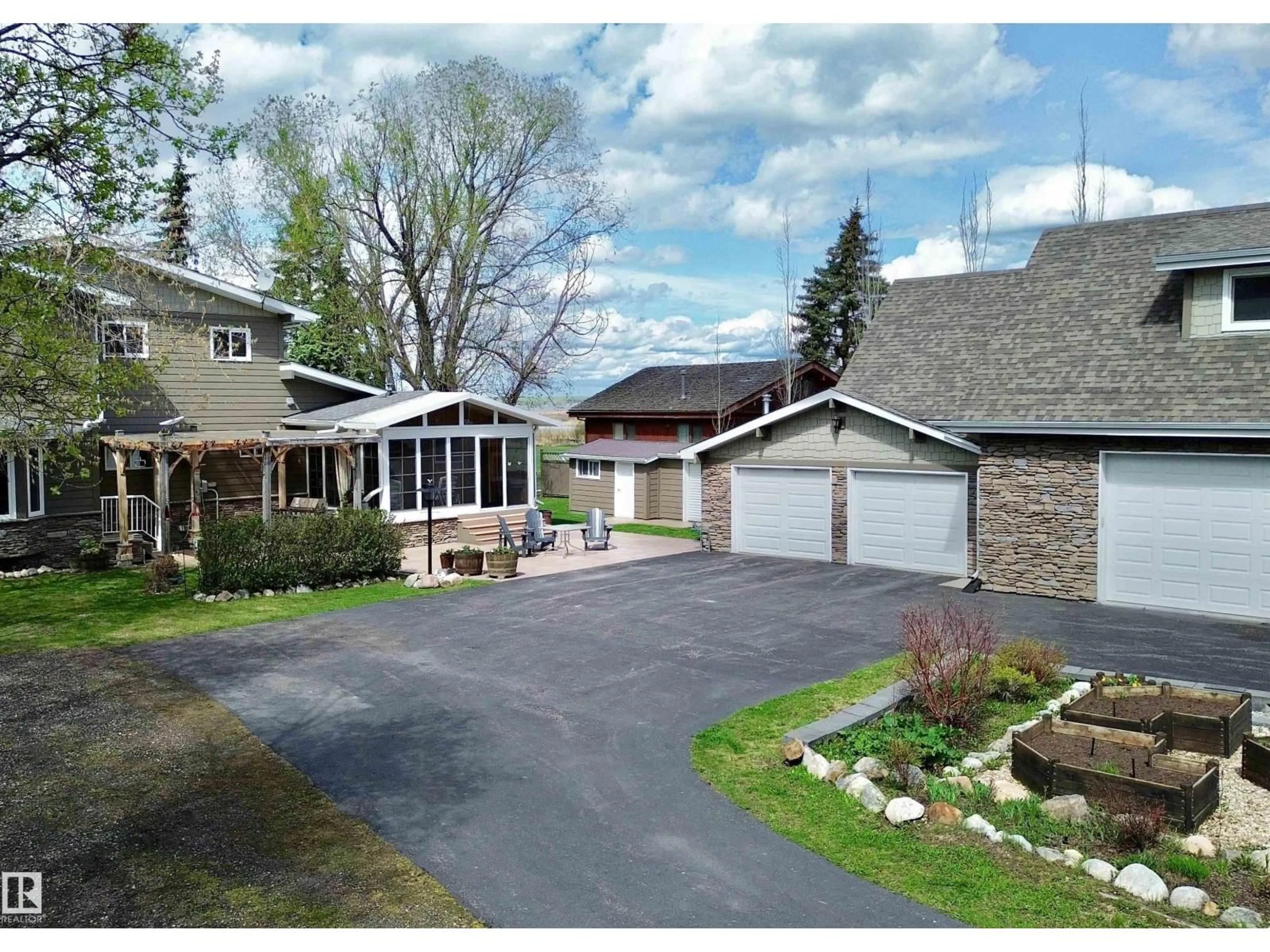 A pic from outside/outdoor area/front of a property/back of a property/a pic from drone, street for #4 - 54524 STE. ANNE TR, Rural Lac Ste. Anne County Alberta T0E0A0