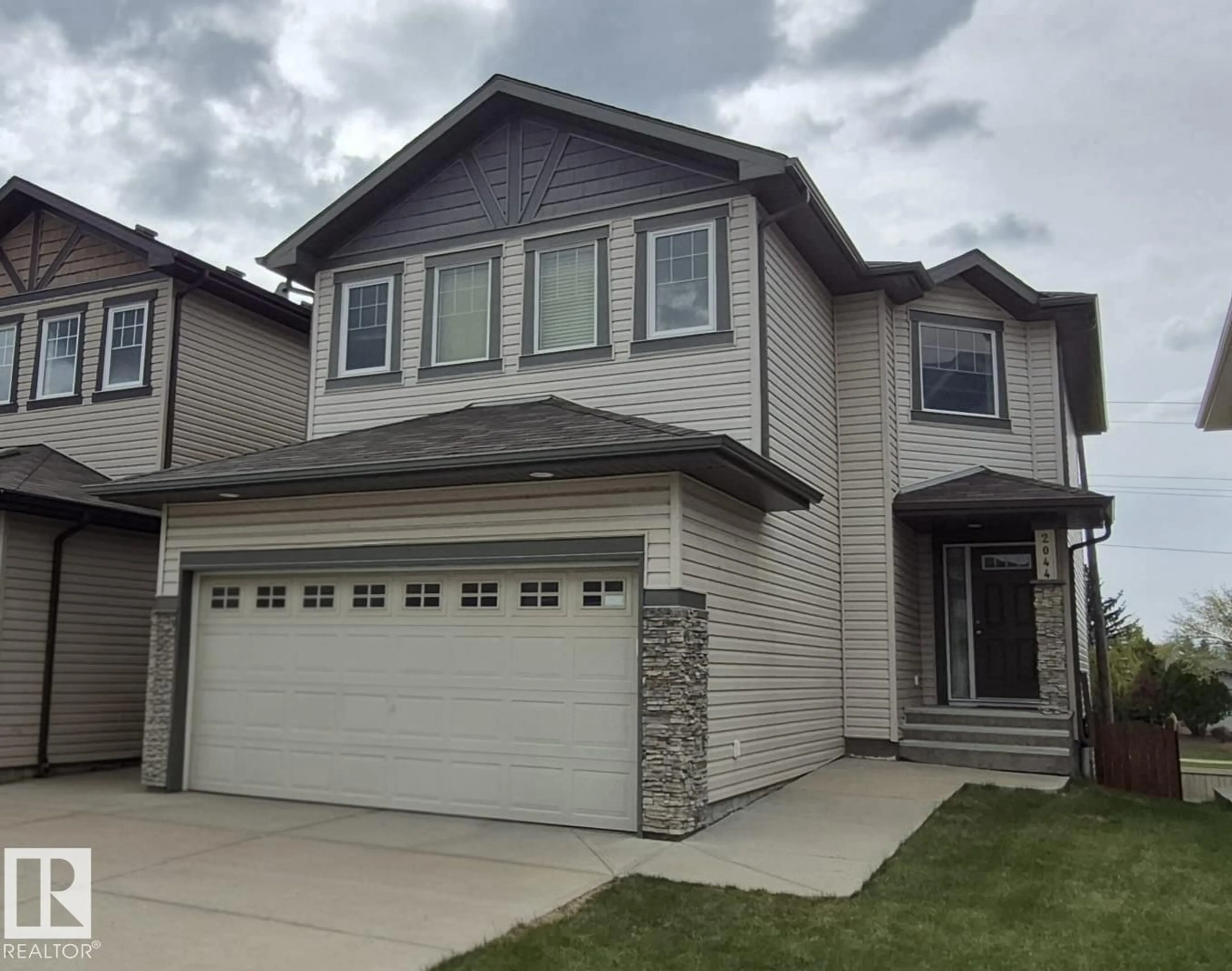 Home with vinyl exterior material, street for NW - 2044 33B ST, Edmonton Alberta T6T0L2
