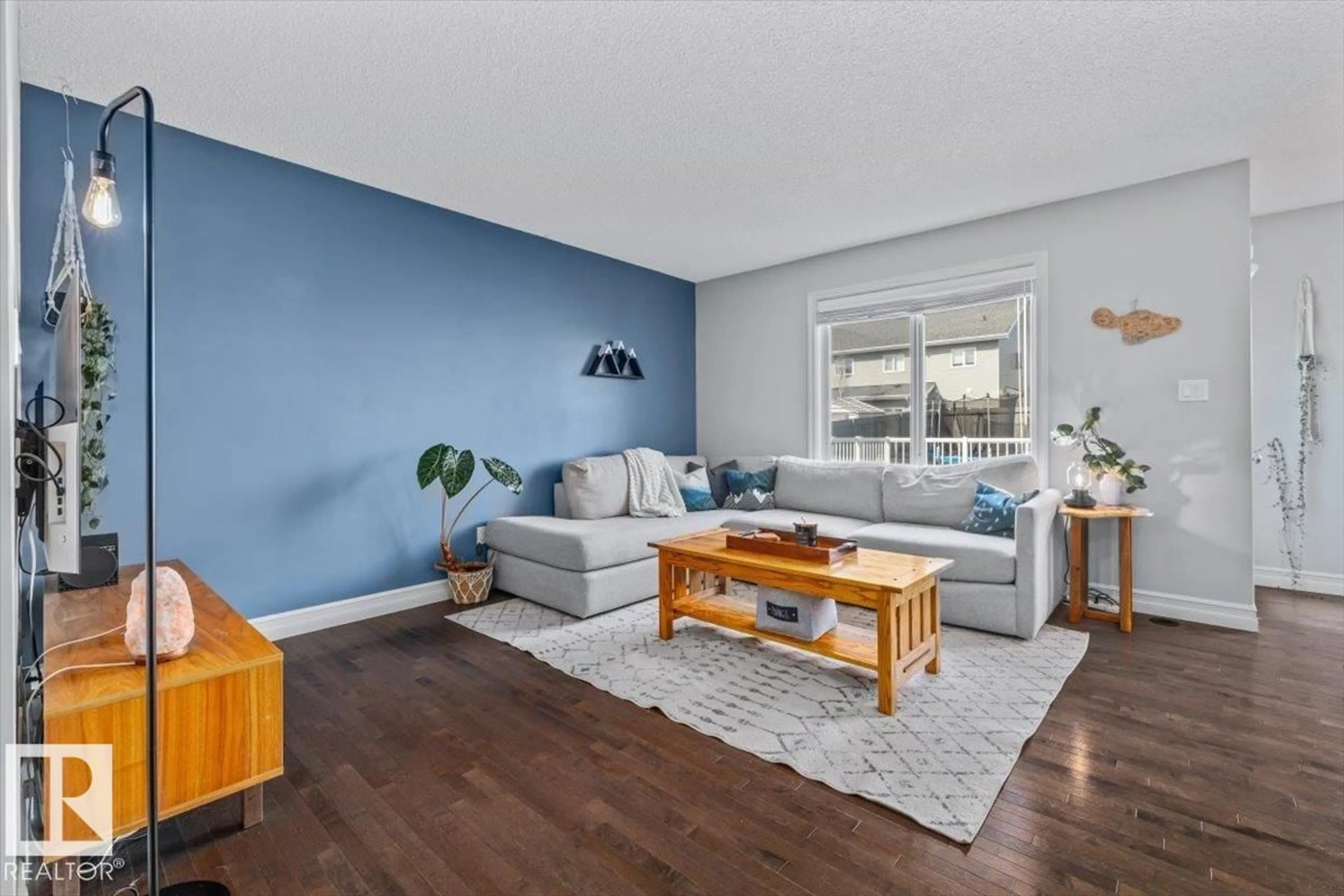 Living room with furniture, wood/laminate floor for 10 DICKENS ST, Fort Saskatchewan Alberta T8L0N4