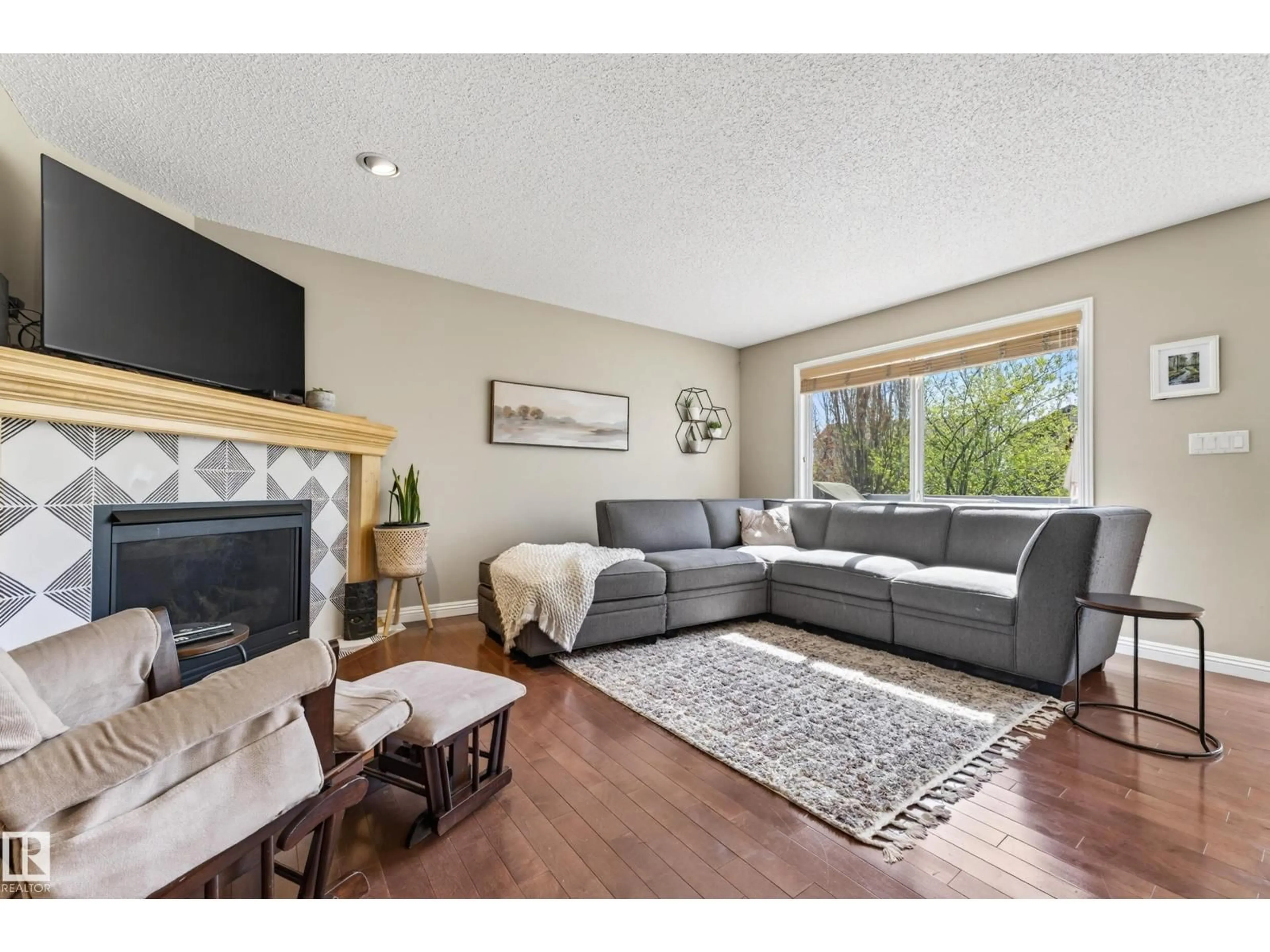 Living room with furniture, wood/laminate floor for 1907 120 ST, Edmonton Alberta T6W0A9