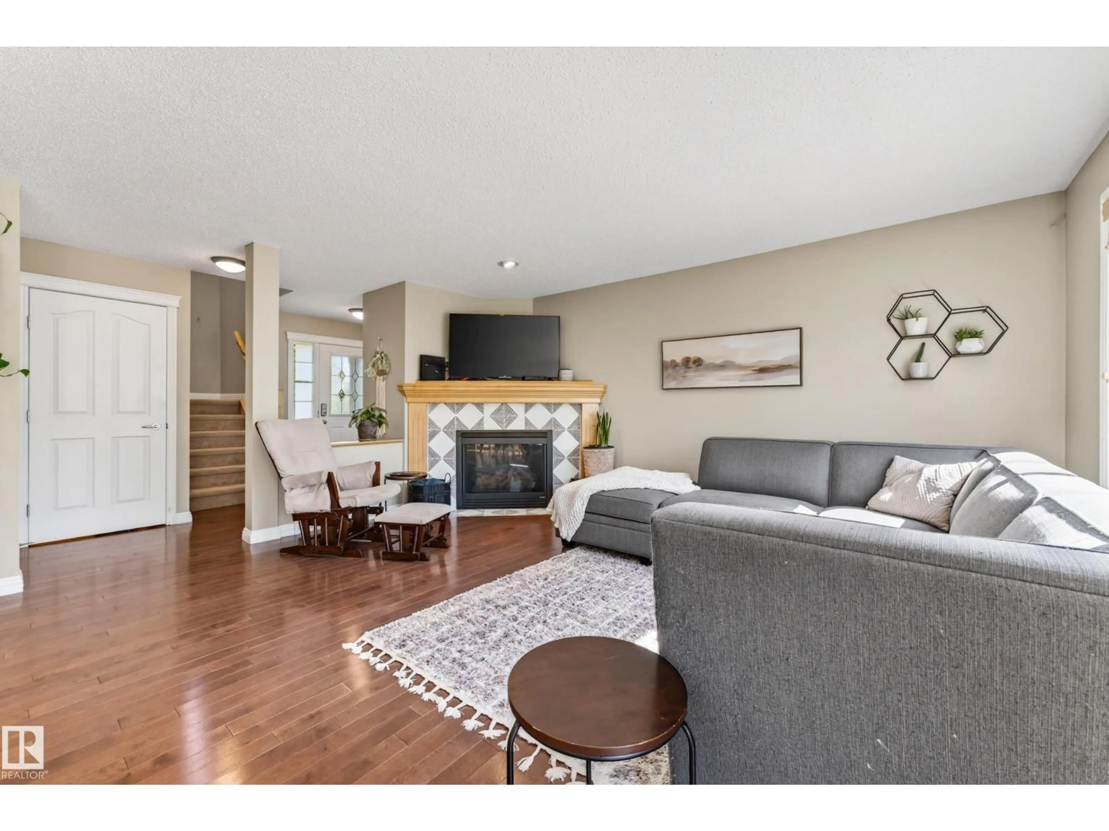 Living room with furniture, wood/laminate floor for 1907 120 ST, Edmonton Alberta T6W0A9