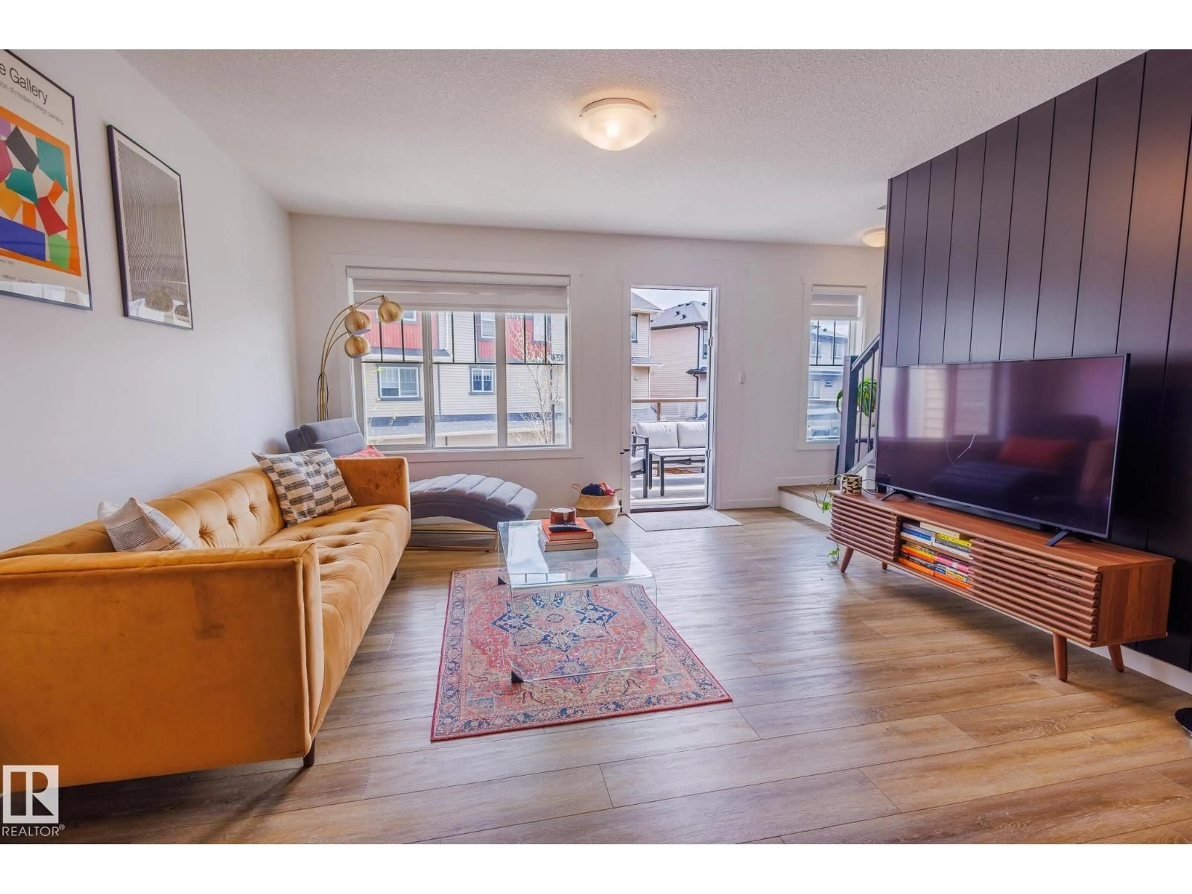 Living room with furniture, wood/laminate floor for #104 - 1530 TAMARACK BV, Edmonton Alberta T6T2E6