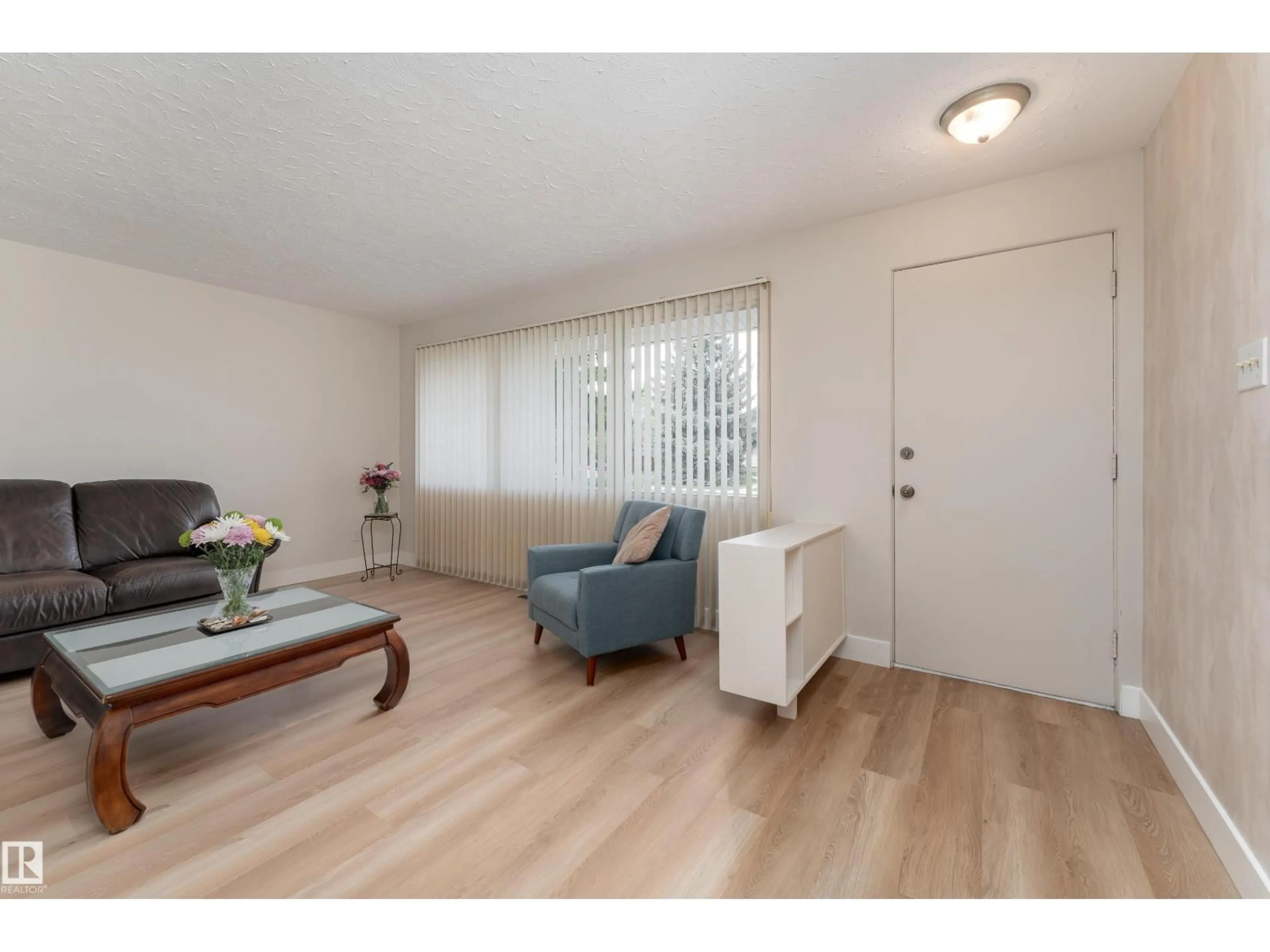 Living room with furniture, wood/laminate floor for 15241 85 AV, Edmonton Alberta T8R3Z8