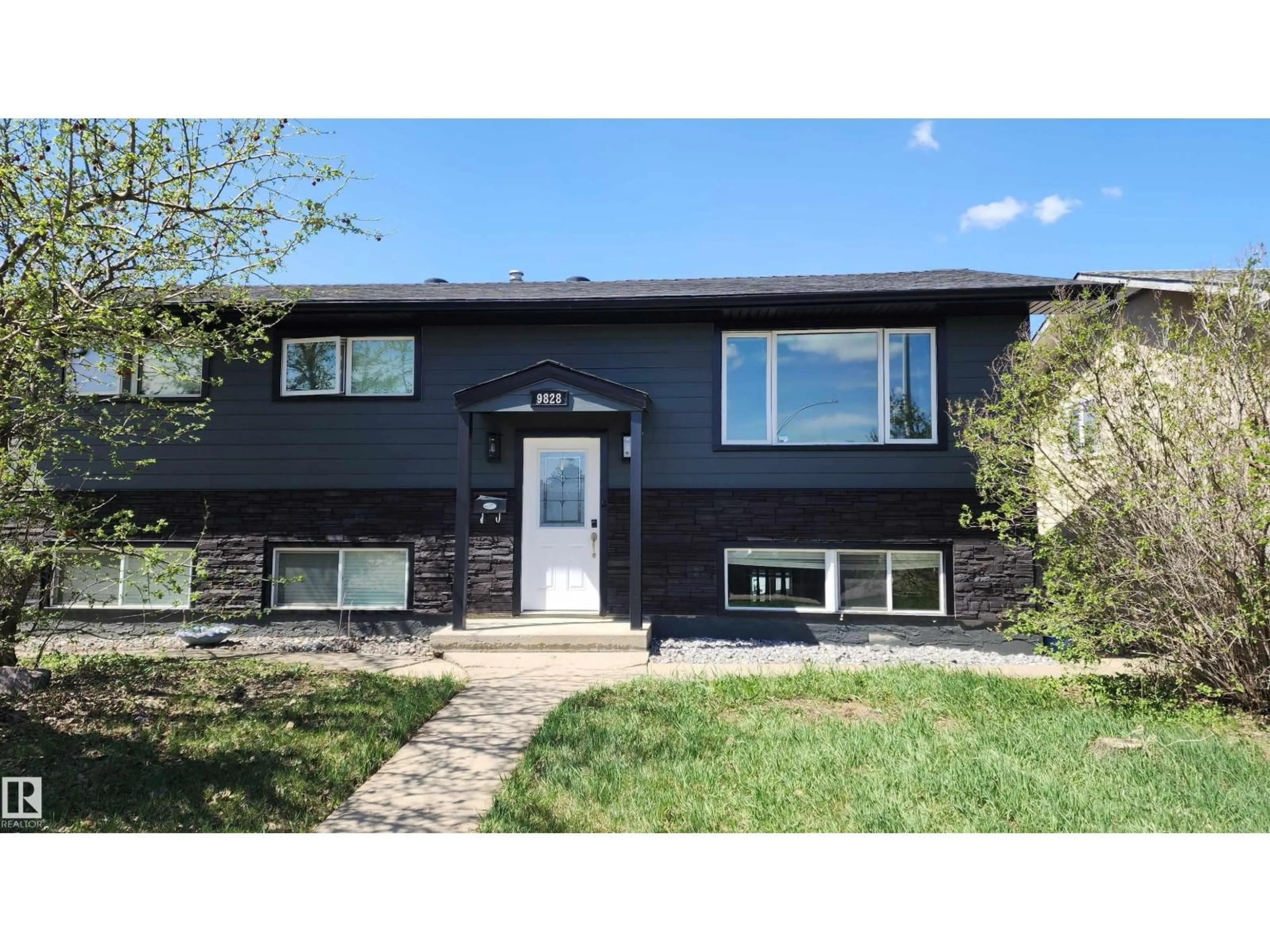 Home with vinyl exterior material, street for NW - 9828 169 ST, Edmonton Alberta T5P3X4