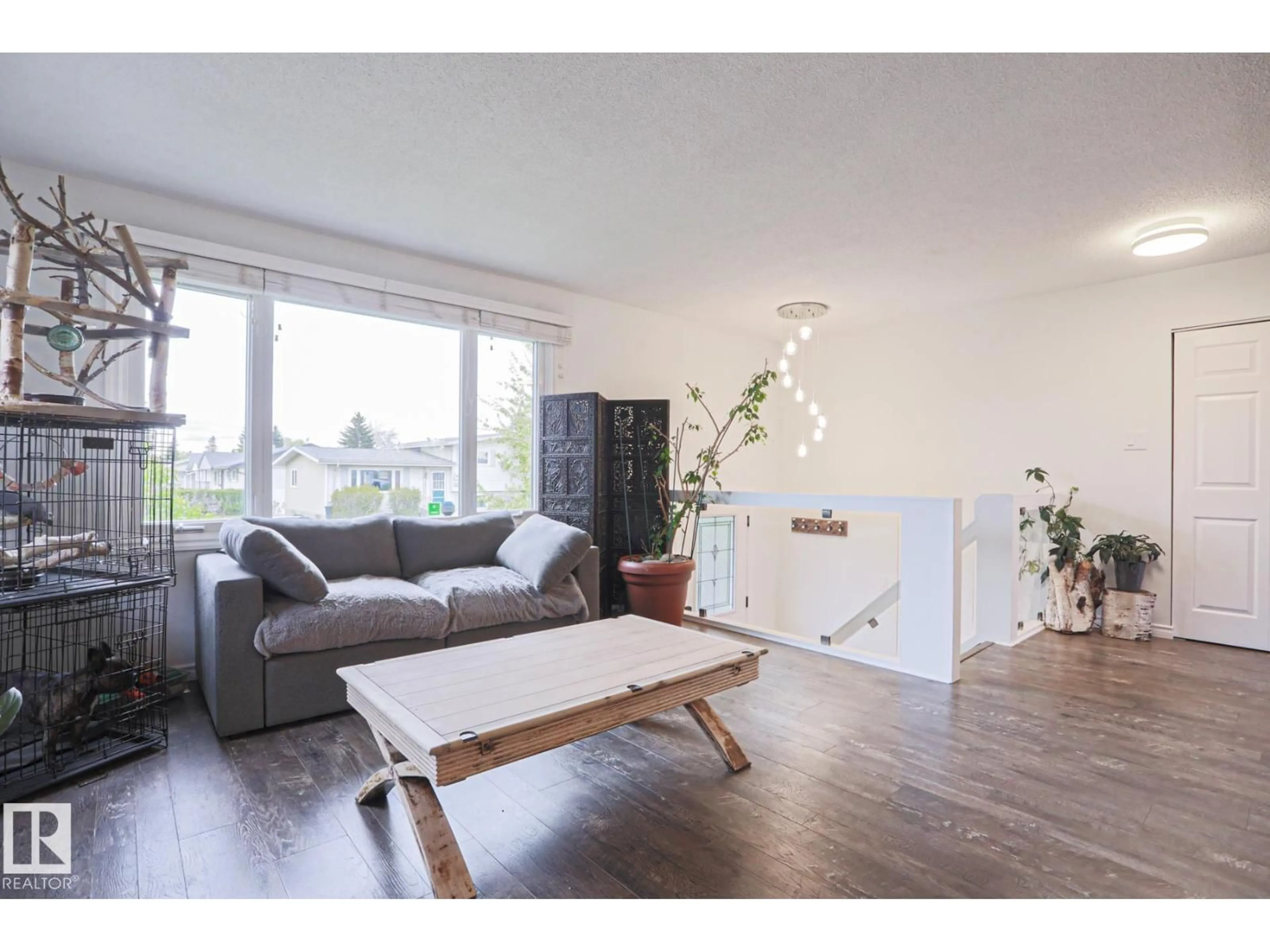 Living room with furniture, wood/laminate floor for NW - 9828 169 ST, Edmonton Alberta T5P3X4