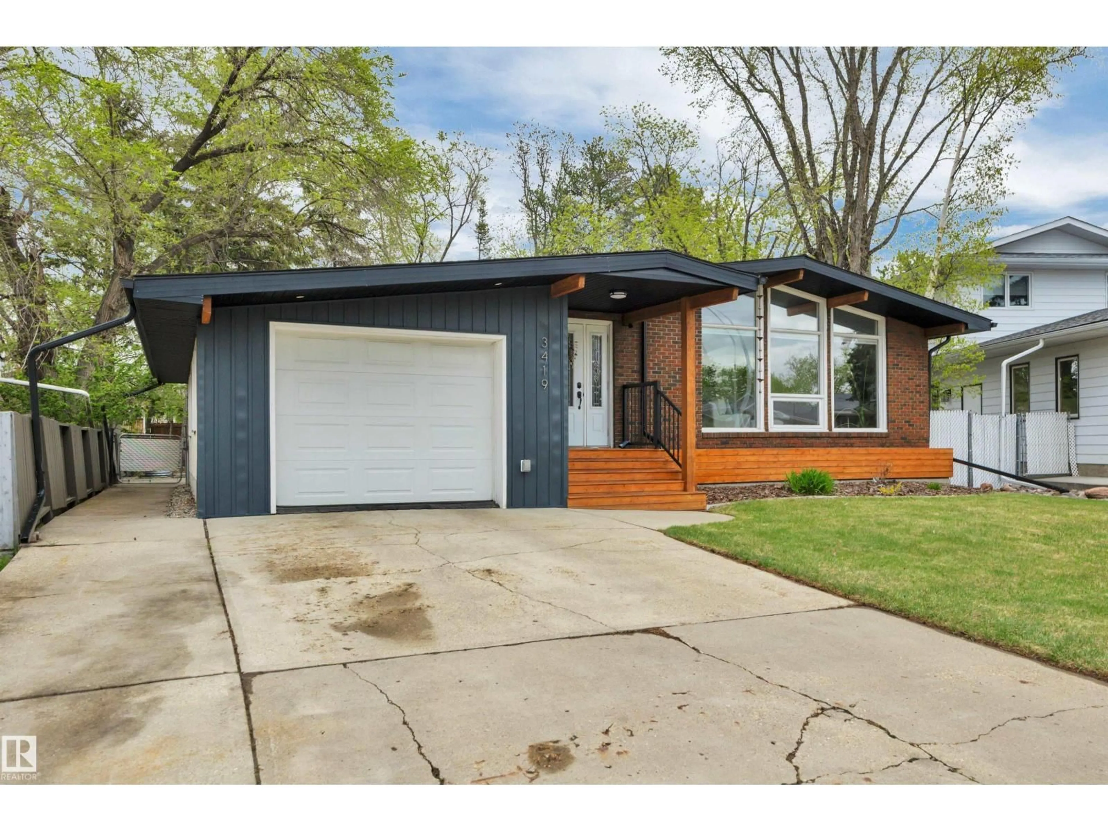 Home with vinyl exterior material, street for 3419 84 ST, Edmonton Alberta T6K0G9