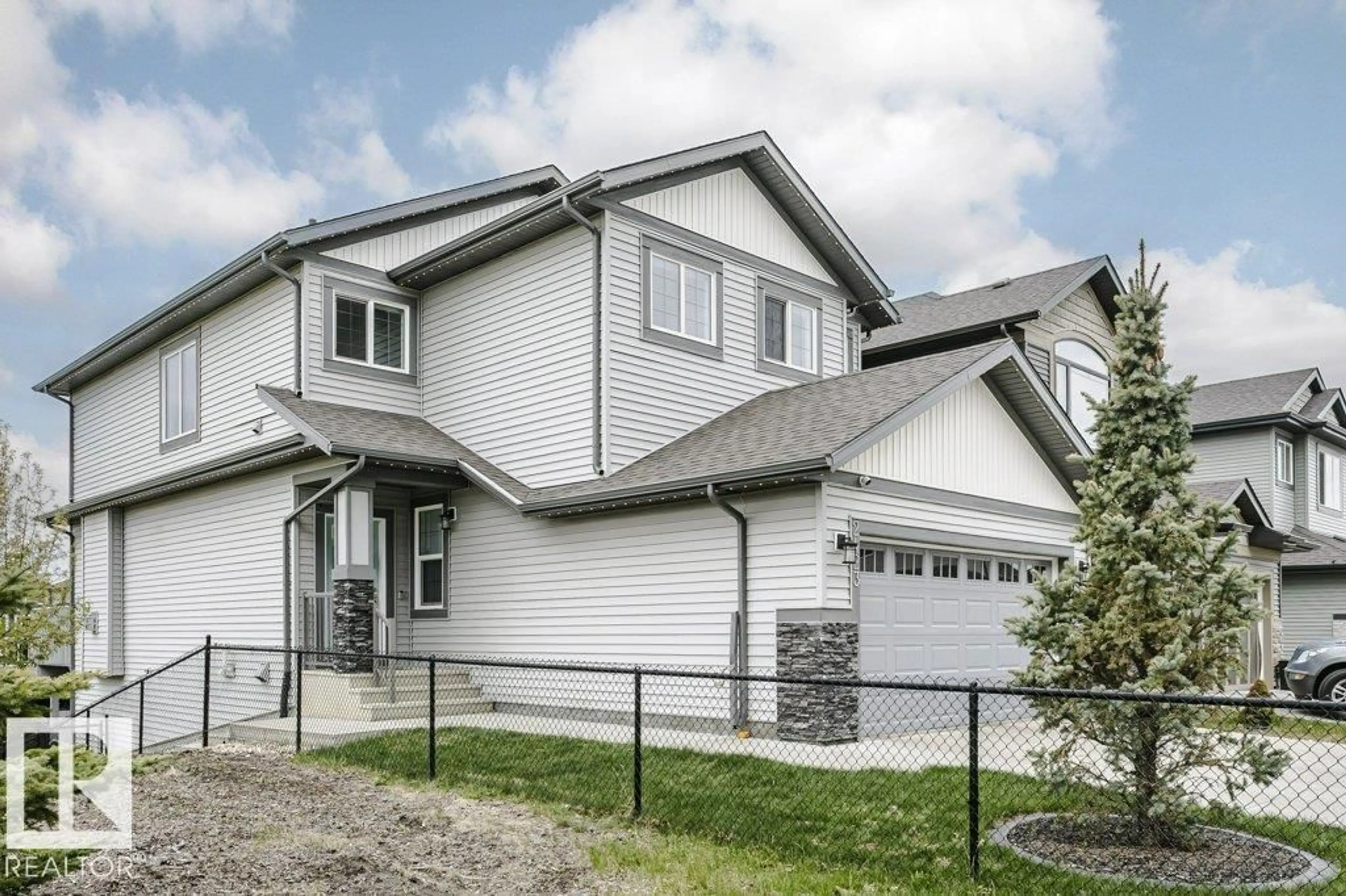 Home with vinyl exterior material, street for 2423 16 AV, Edmonton Alberta T6T2H5