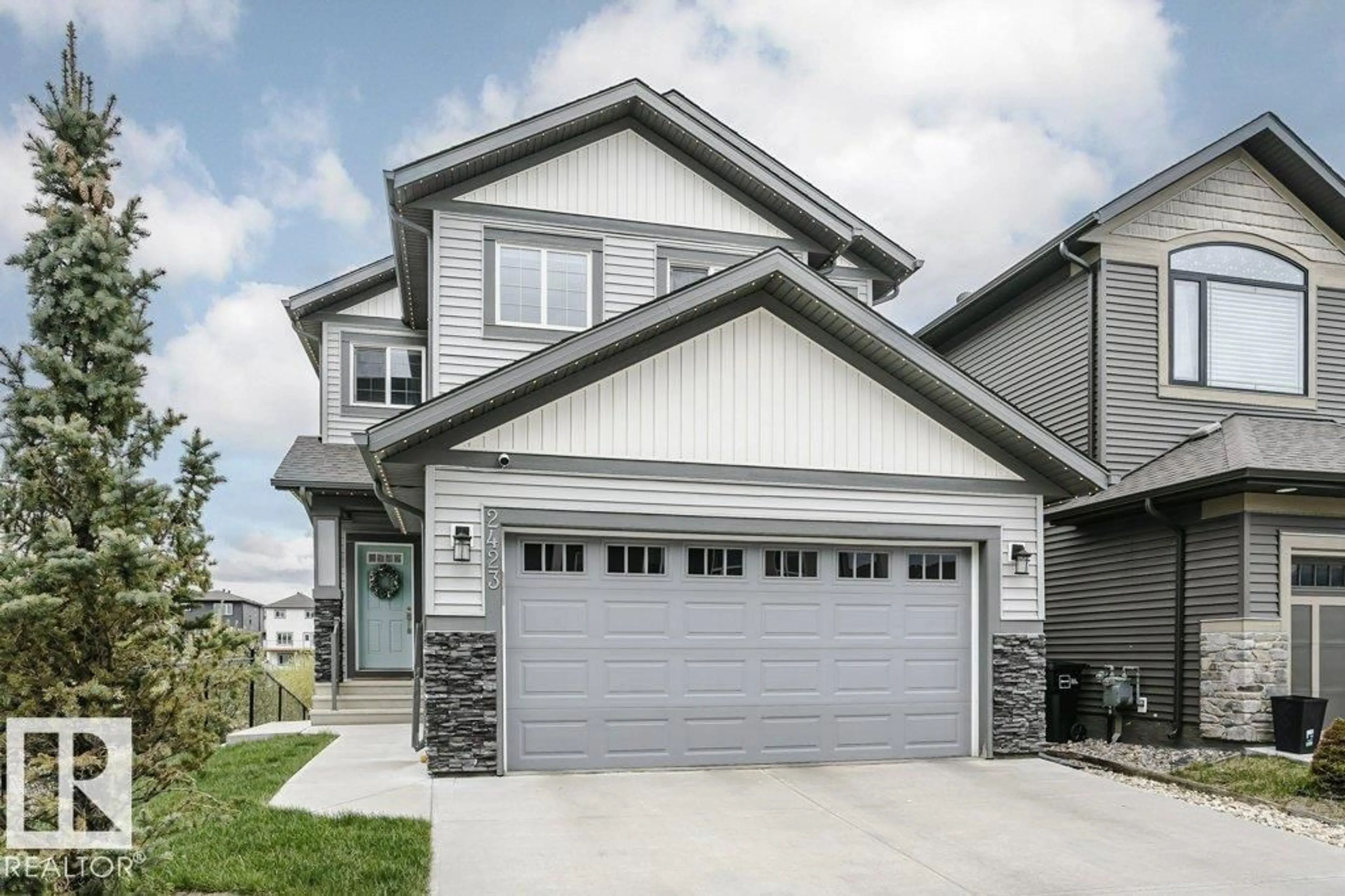 Home with vinyl exterior material, street for 2423 16 AV, Edmonton Alberta T6T2H5