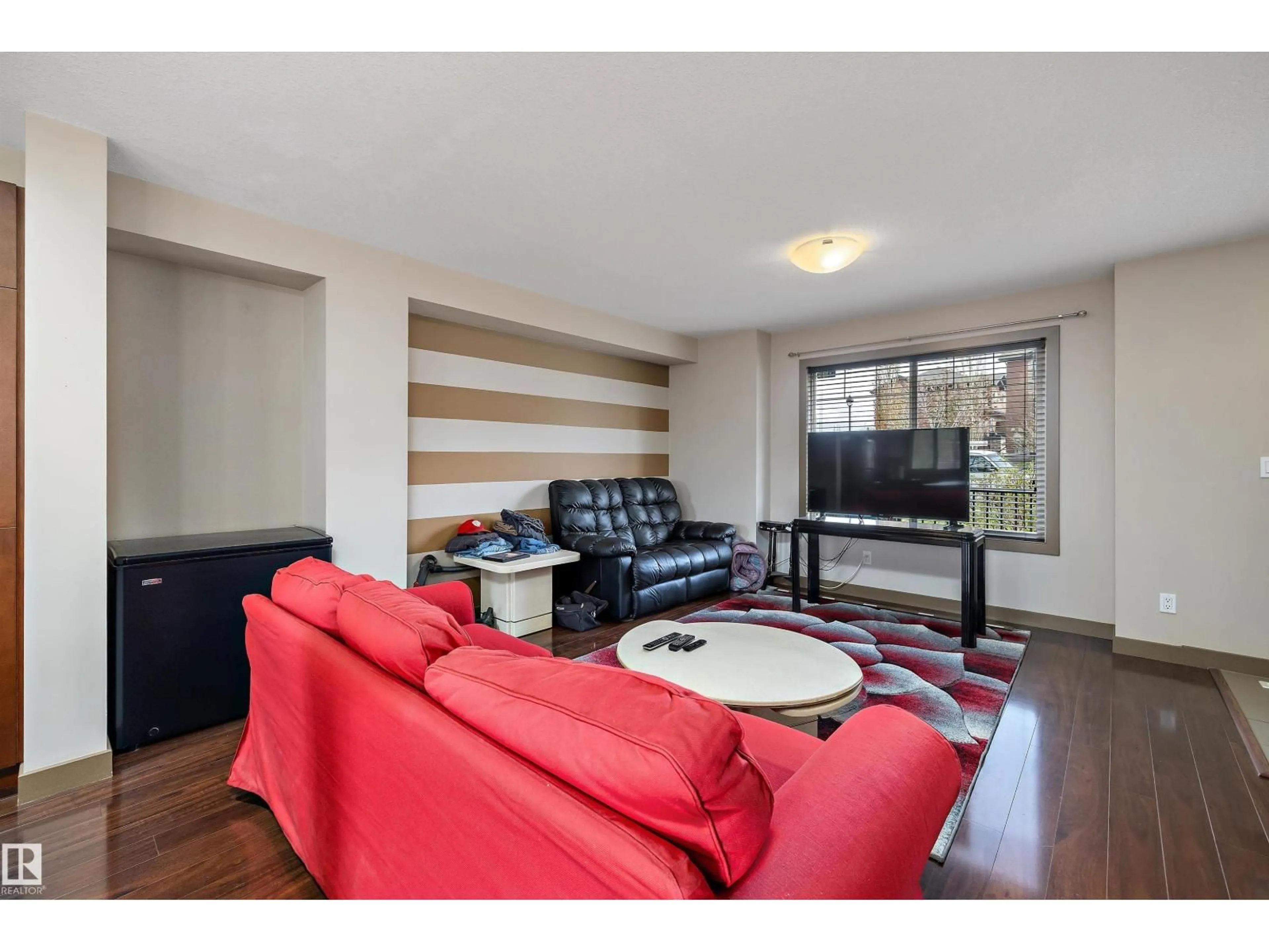 Living room with furniture, wood/laminate floor for #403 - 401 PALISADES WY, Sherwood Park Alberta T8H0R7