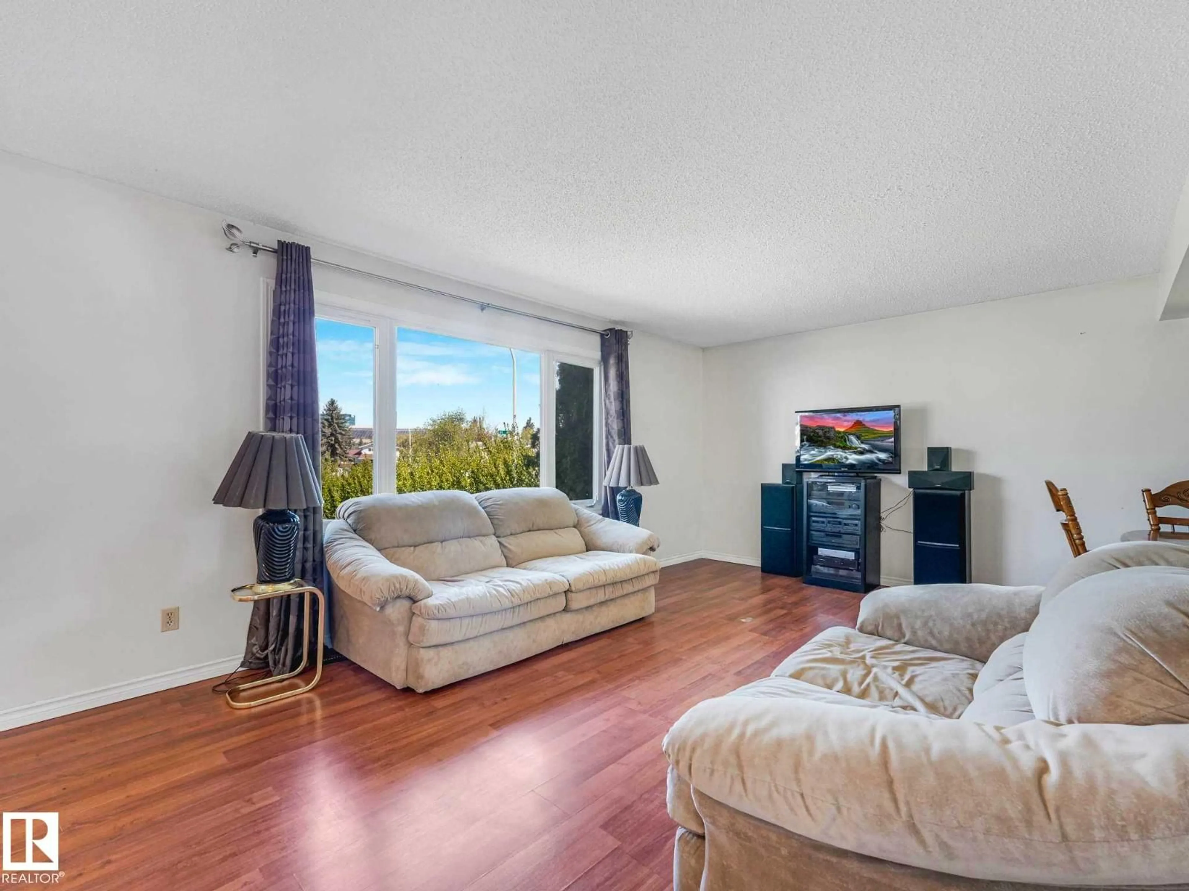 Living room with furniture, wood/laminate floor for 17603 84 AV NW, Edmonton Alberta T5T0K5