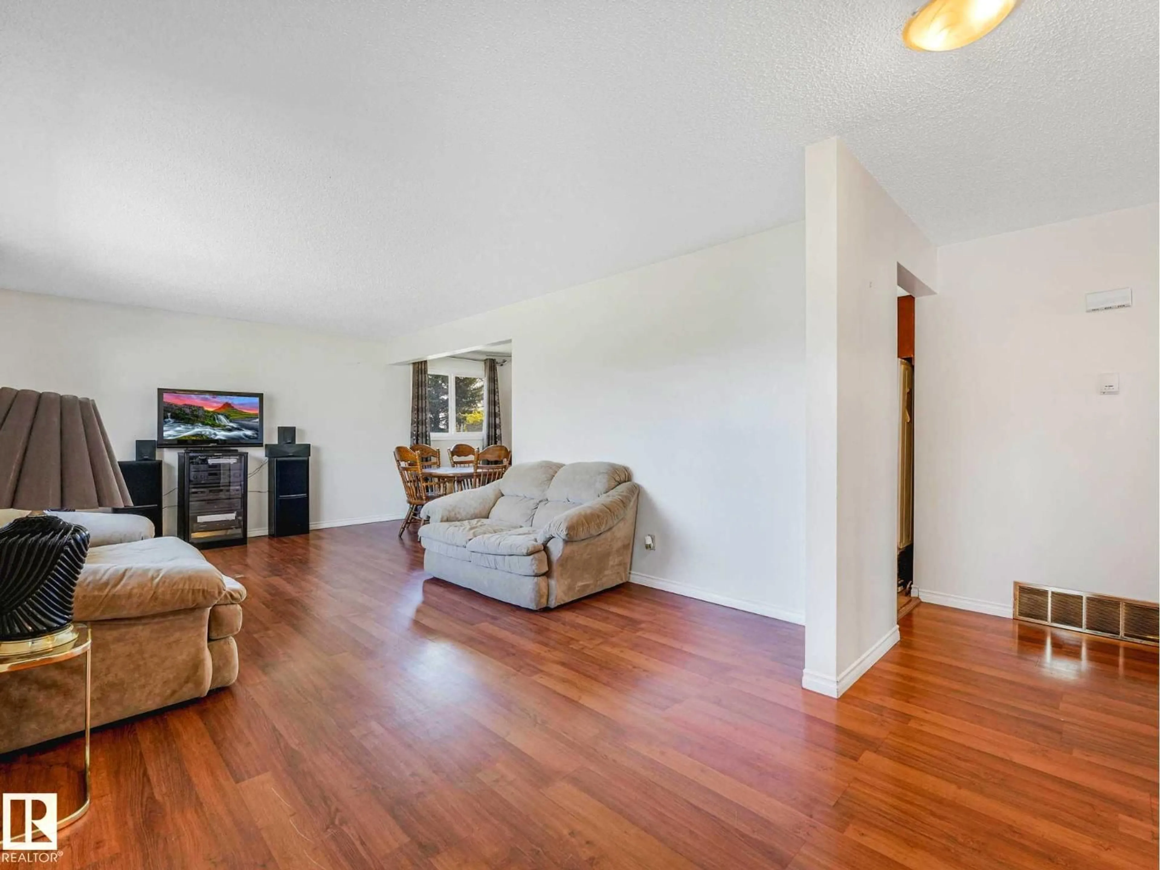 Living room with furniture, wood/laminate floor for 17603 84 AV NW, Edmonton Alberta T5T0K5