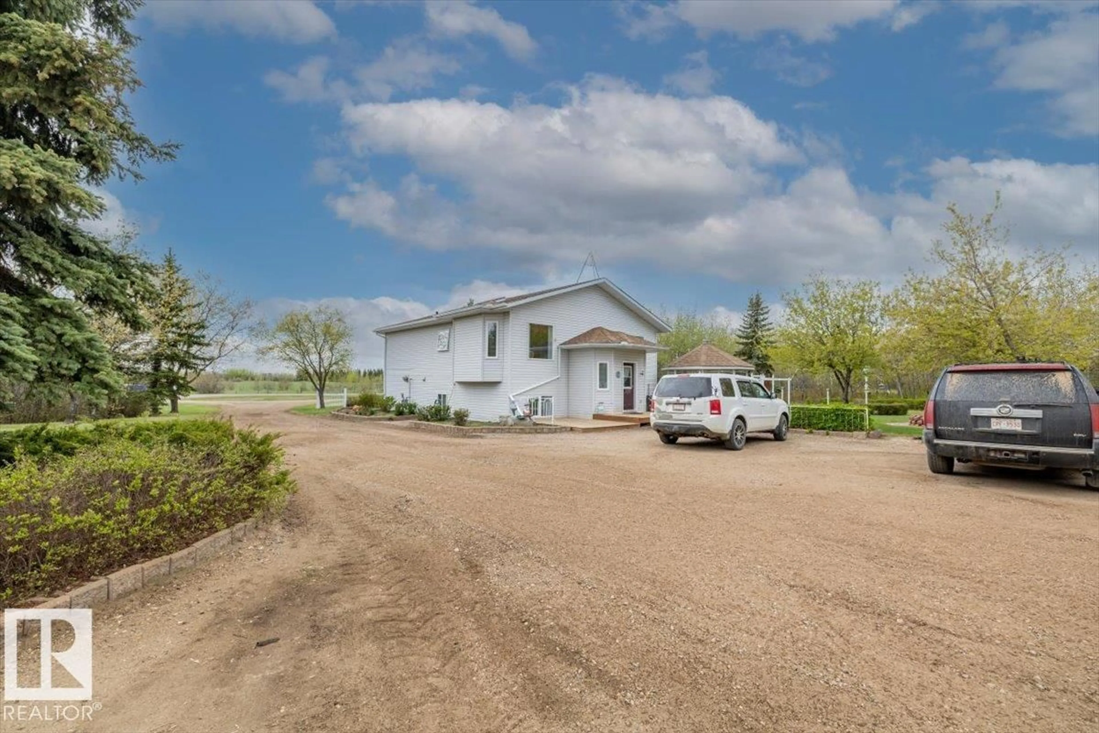 A pic from outside/outdoor area/front of a property/back of a property/a pic from drone, street for #11 - 22515 TWP ROAD 575 A, Rural Sturgeon County Alberta T0A1N6