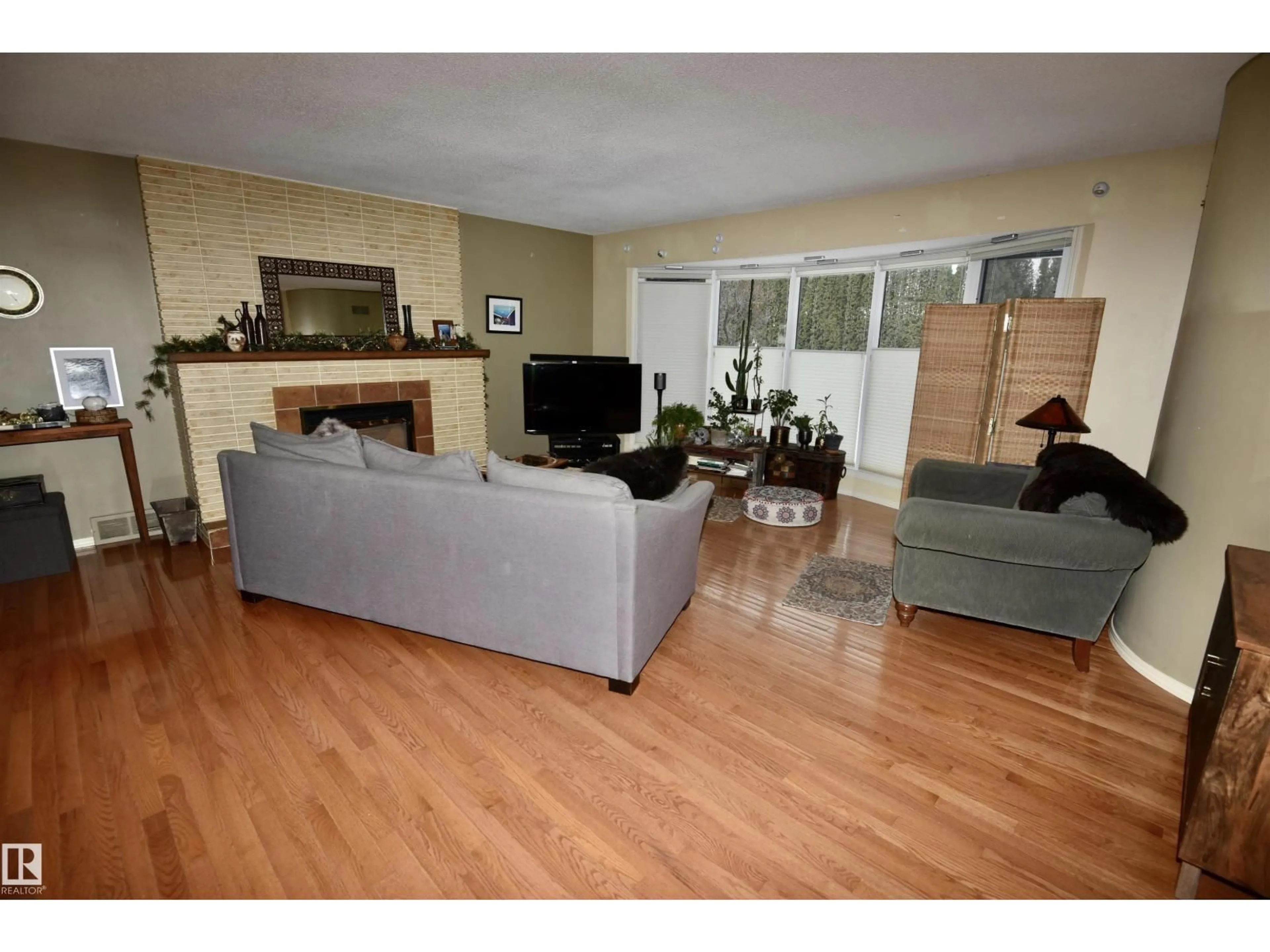 Living room with furniture, wood/laminate floor for 13910 101A AV, Edmonton Alberta T5N0L2
