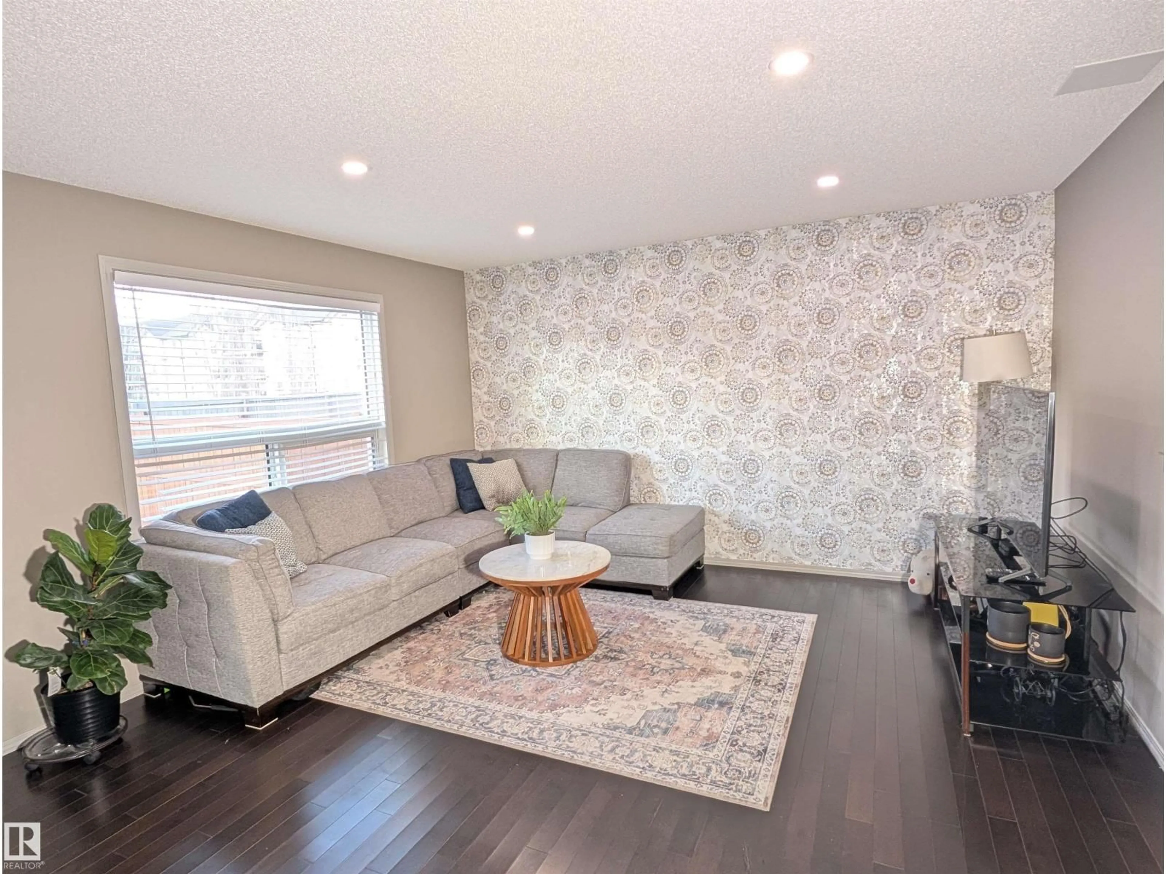 Living room with furniture, wood/laminate floor for NW - 3336 17B AV, Edmonton Alberta T6T0P3
