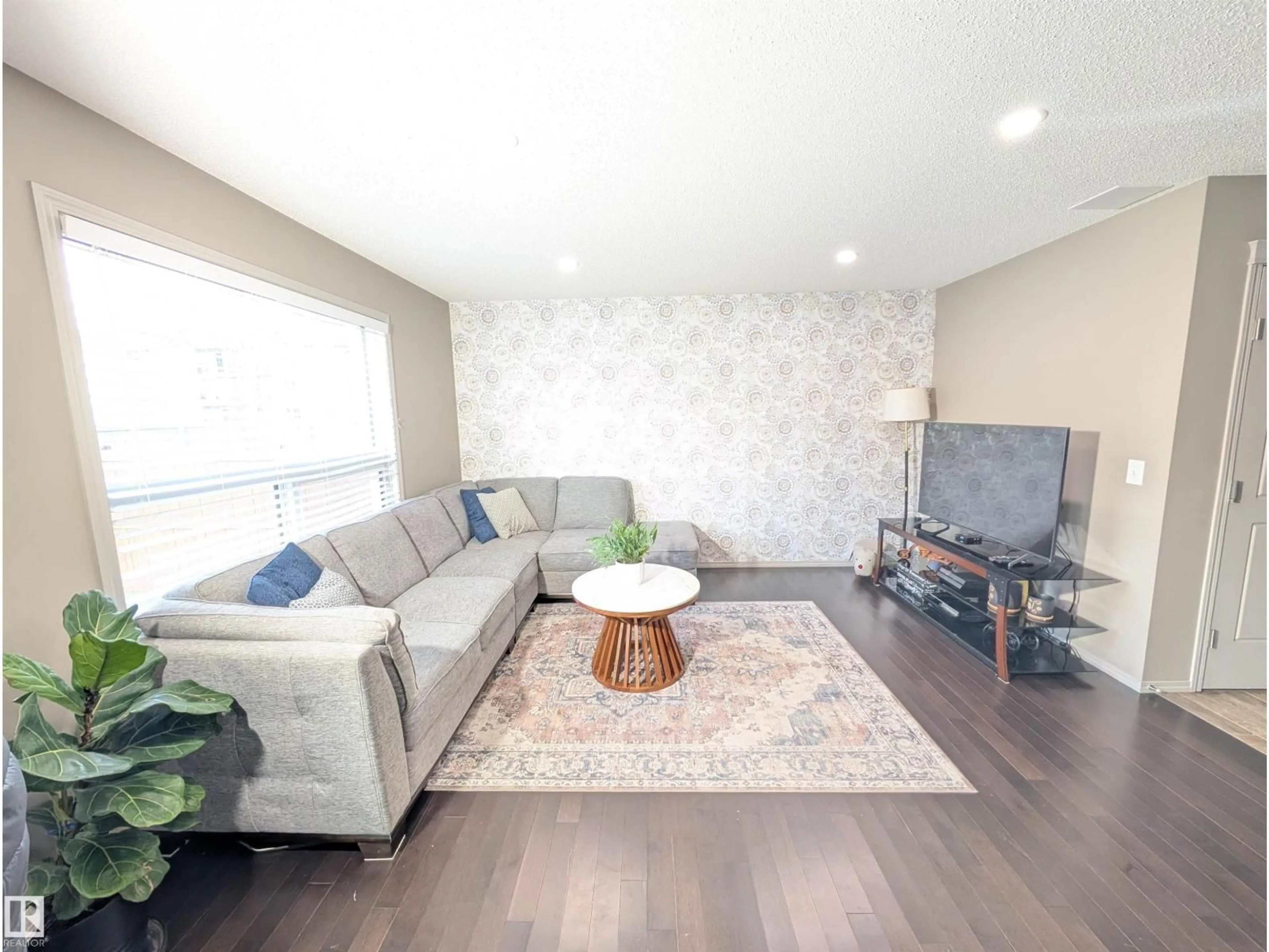 Living room with furniture, wood/laminate floor for NW - 3336 17B AV, Edmonton Alberta T6T0P3