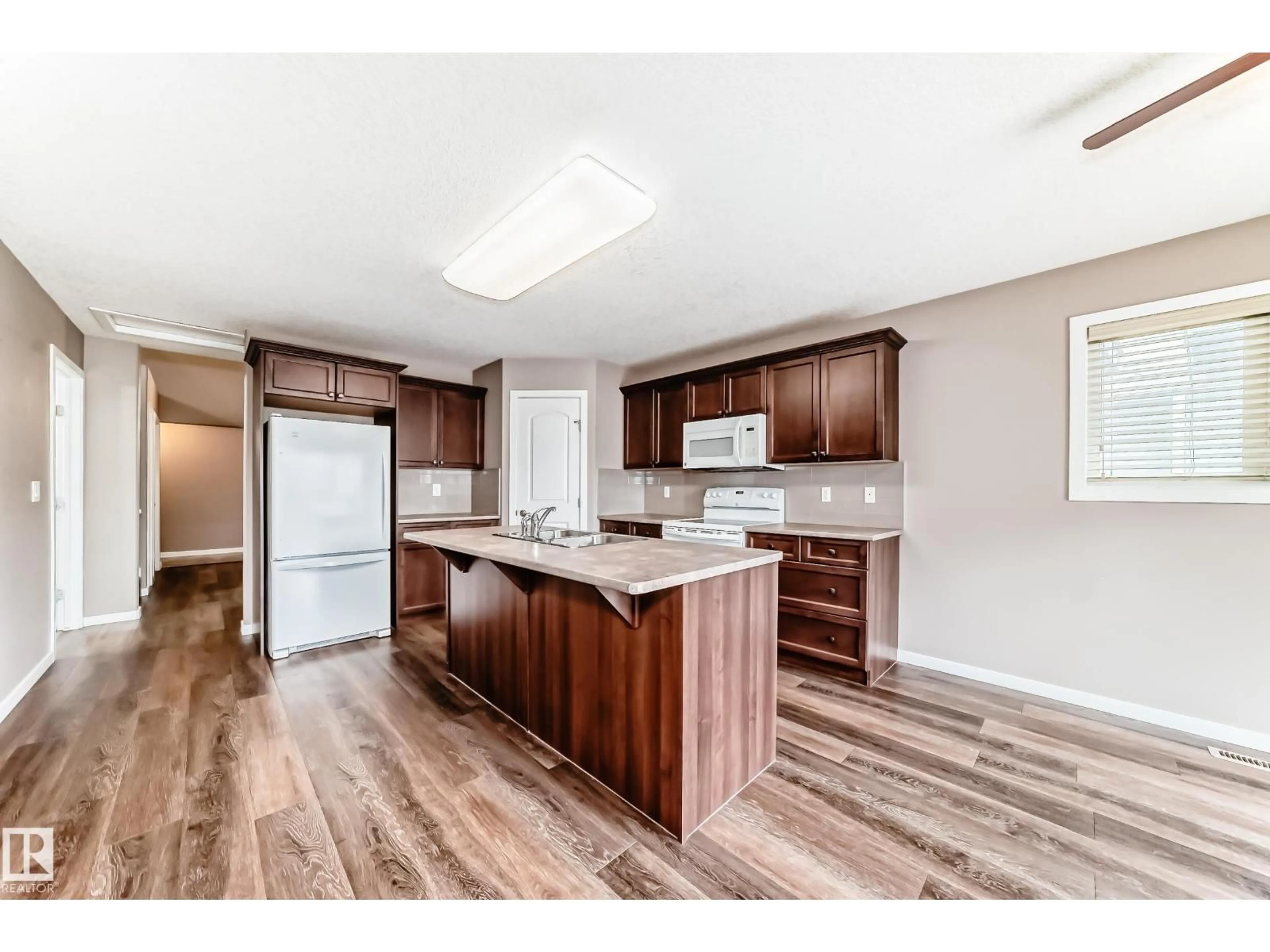Open concept kitchen, wood/laminate floor for 16737 60ST NW, Edmonton Alberta T5Y0W5
