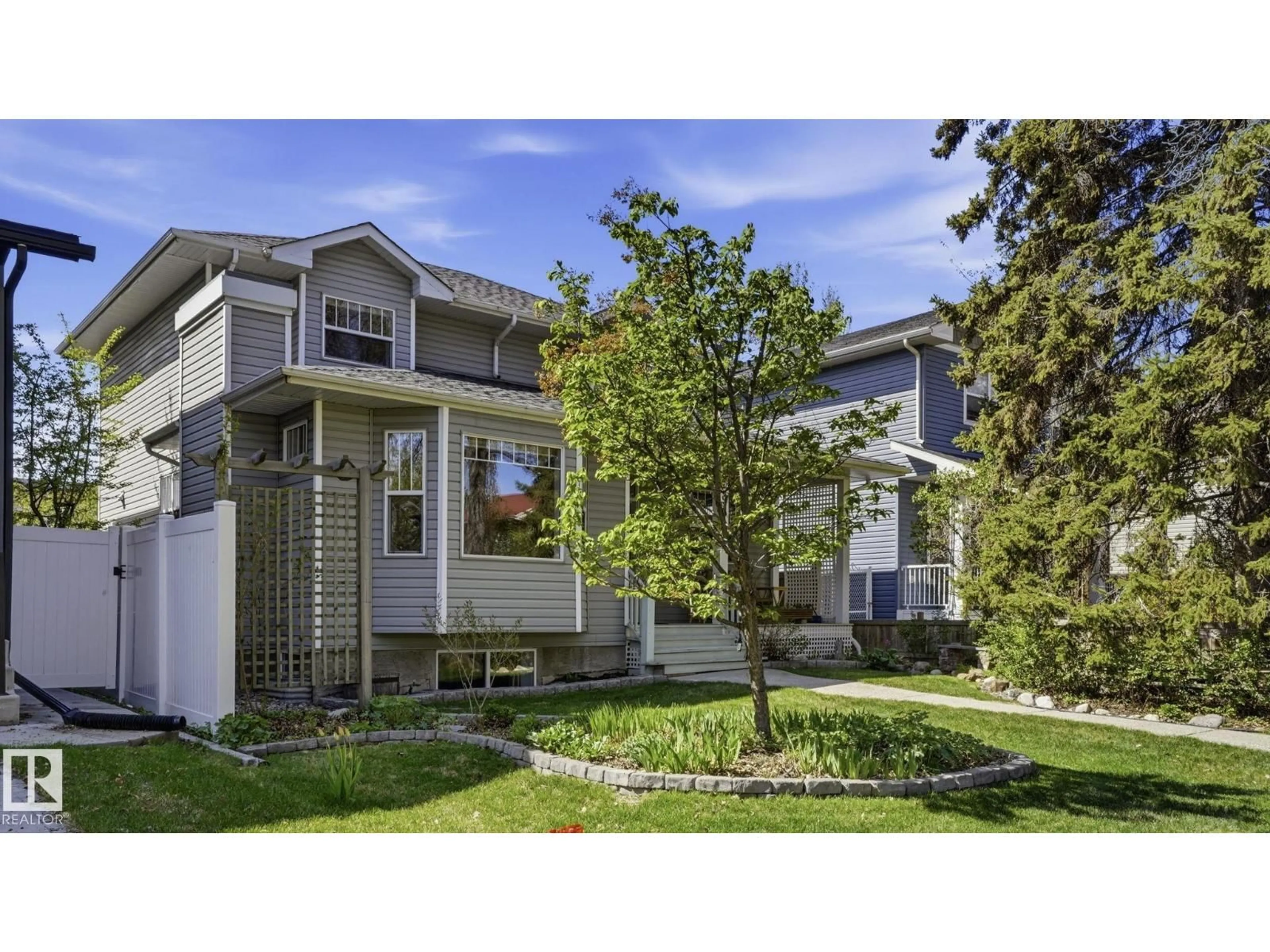 Home with vinyl exterior material, street for 9611 77 AV NW, Edmonton Alberta T6C0M4